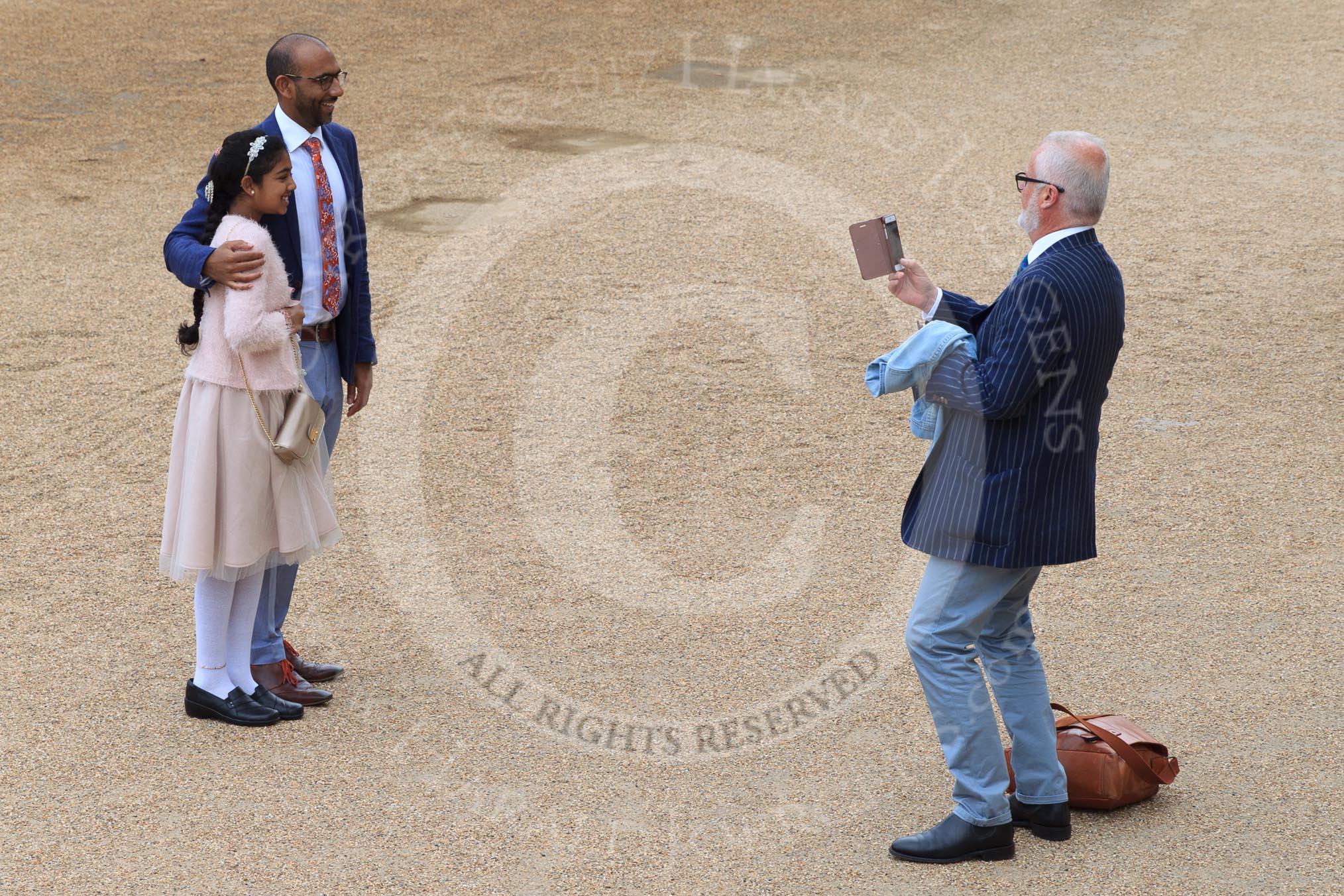 Father and daughter having their photo taken before The Colonel's Review 2018 (final rehearsal for Trooping the Colour, The Queen's Birthday Parade)  at Horse Guards Parade, Westminster, London, 2 June 2018, 09:28.