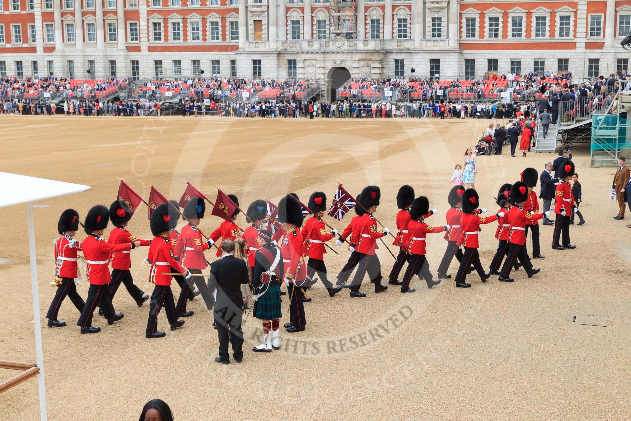 The 'Keepers of the Ground', guardsmen bearing marker flags for their respective regiments, marching towards Horse Guards Arch before The Colonel's Review 2018 (final rehearsal for Trooping the Colour, The Queen's Birthday Parade)  at Horse Guards Parade, Westminster, London, 2 June 2018, 09:53.