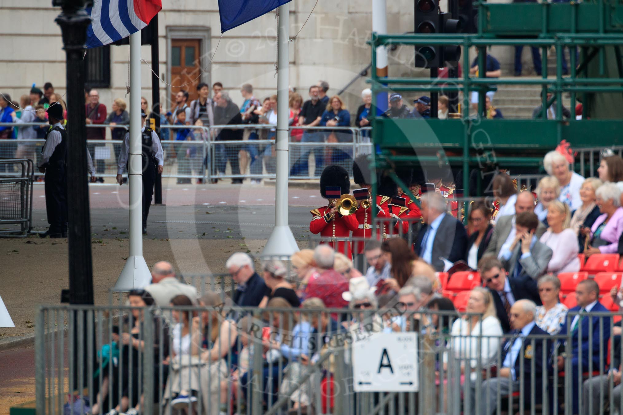 The Band of the Welsh Guards in the background, turning from The Mall to Horse Guards Parade during The Colonel's Review 2018 (final rehearsal for Trooping the Colour, The Queen's Birthday Parade)  at Horse Guards Parade, Westminster, London, 2 June 2018, 10:11.