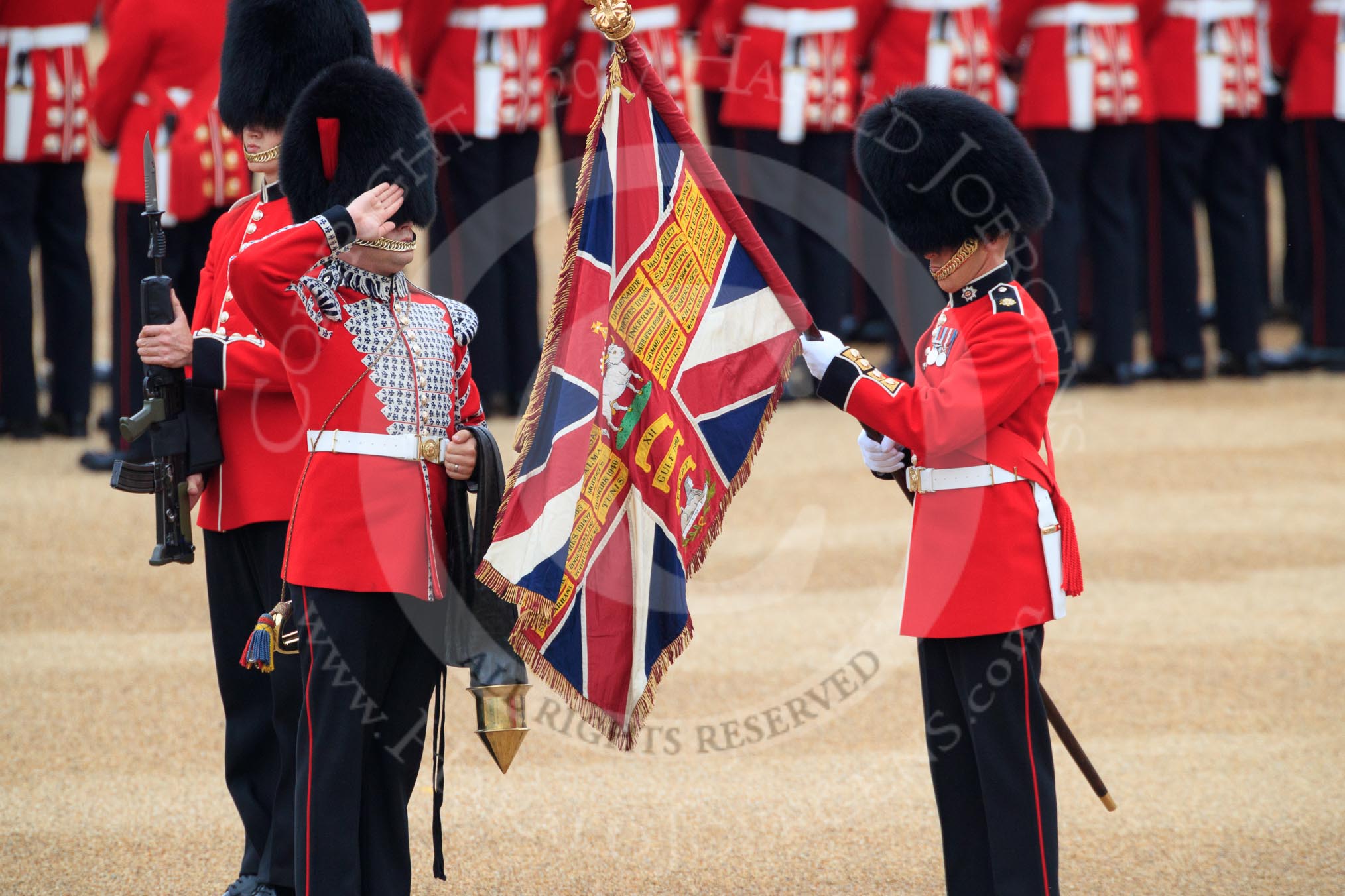 Duty Drummer  Sam Orchard saluting the uncased Colour held by Colour Sergeant Sam McAuley (31), with Colour Sentry Guardsman Jonathon Hughes (26) behind, during The Colonel's Review 2018 (final rehearsal for Trooping the Colour, The Queen's Birthday Parade)  at Horse Guards Parade, Westminster, London, 2 June 2018, 10:33.