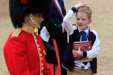 Young boy carrying an event programme and looking up to a Captain of the Coldstream Guards before The Colonel's Review 2018 (final rehearsal for Trooping the Colour, The Queen's Birthday Parade)  at Horse Guards Parade, Westminster, London, 2 June 2018, 09:46.