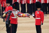 Duty Drummer  Sam Orchard uncasing the Colour held by Colour Sergeant Sam McAuley (31), with Colour Sentry Guardsman Jonathon Hughes (26) behind, during The Colonel's Review 2018 (final rehearsal for Trooping the Colour, The Queen's Birthday Parade)  at Horse Guards Parade, Westminster, London, 2 June 2018, 10:33.