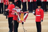 Duty Drummer  Sam Orchard uncasing the Colour held by Colour Sergeant Sam McAuley (31), with Colour Sentry Guardsman Jonathon Hughes (26) behind, during The Colonel's Review 2018 (final rehearsal for Trooping the Colour, The Queen's Birthday Parade)  at Horse Guards Parade, Westminster, London, 2 June 2018, 10:33.