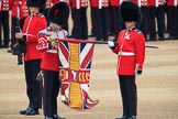 Duty Drummer  Sam Orchard uncasing the Colour held by Colour Sergeant Sam McAuley (31), with Colour Sentry Guardsman Jonathon Hughes (26) behind, during The Colonel's Review 2018 (final rehearsal for Trooping the Colour, The Queen's Birthday Parade)  at Horse Guards Parade, Westminster, London, 2 June 2018, 10:33.