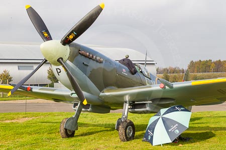 The Spitfire during the photography work at Duxford Aerodrome. The photographer's workplace is under the wing, shielded against the low sun by a Boat Race umbrella.