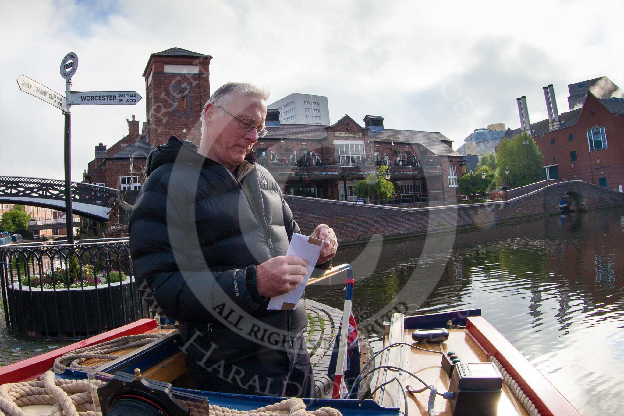 BCN Marathon Challenge 2013: Skipper Charley on board of NB "Felonious Mongoose", at Old Street Junction in the centre of Birmingham, at the start of the BCN Marathon Challenge, opening the sealed envelope with the challenges..
Birmingham Canal Navigation,


United Kingdom,
on 25 May 2013 at 07:58, image #28