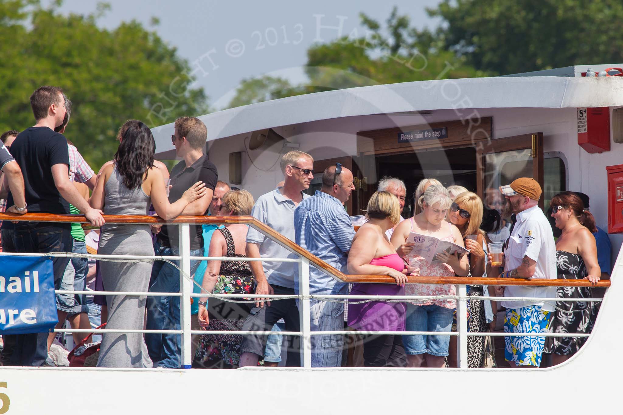 TOW River Thames Barge Driving Race 2013: Passengers on board the "Golden Jubilee" studying the race programme..
River Thames between Greenwich and Westminster,
London,

United Kingdom,
on 13 July 2013 at 11:31, image #28