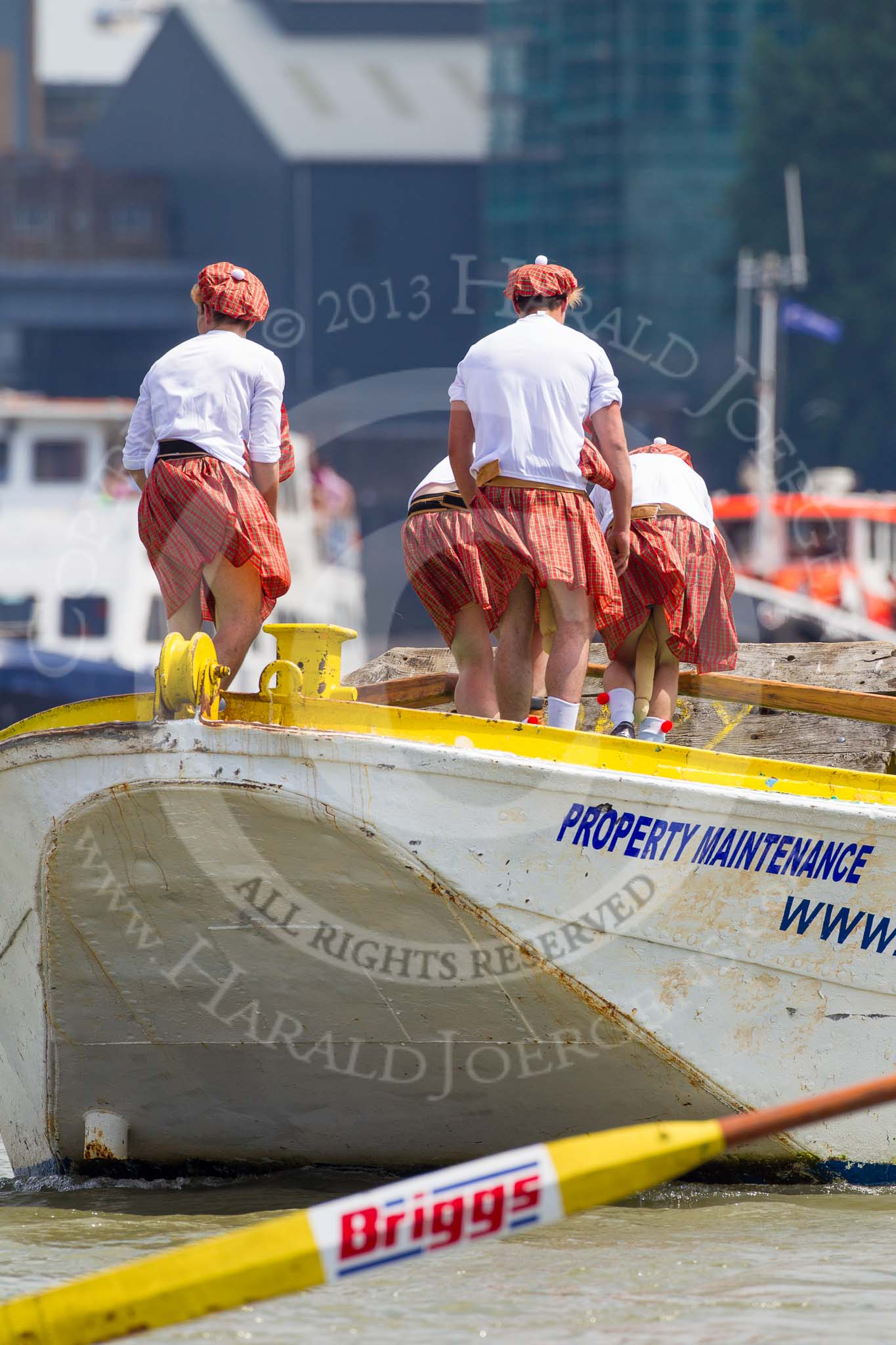 TOW River Thames Barge Driving Race 2013: Rowers wearing skirts on the deck of of barge "Hoppy" by GPS Fabrication..
River Thames between Greenwich and Westminster,
London,

United Kingdom,
on 13 July 2013 at 12:38, image #138