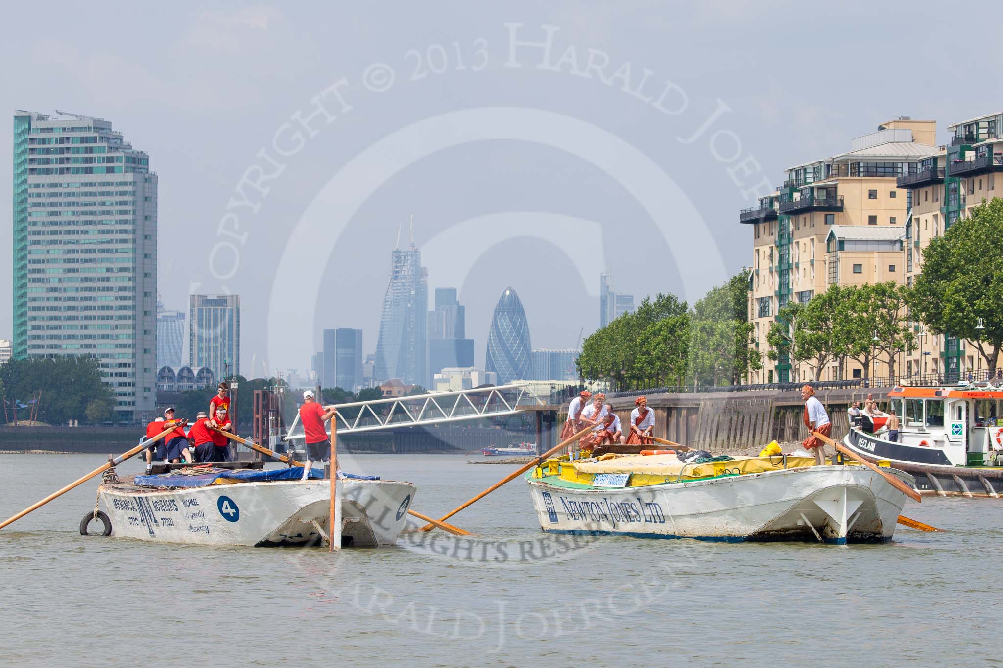 TOW River Thames Barge Driving Race 2013: Barge "Hoppy", by GPS Fabrication, approaching Masthouse Terrace Pier. On the left barge "Spirit of Mountabatten", by Mechanical Movements and Enabling Services Ltd. In the background the skyscrapers of the City of London..
River Thames between Greenwich and Westminster,
London,

United Kingdom,
on 13 July 2013 at 12:41, image #169