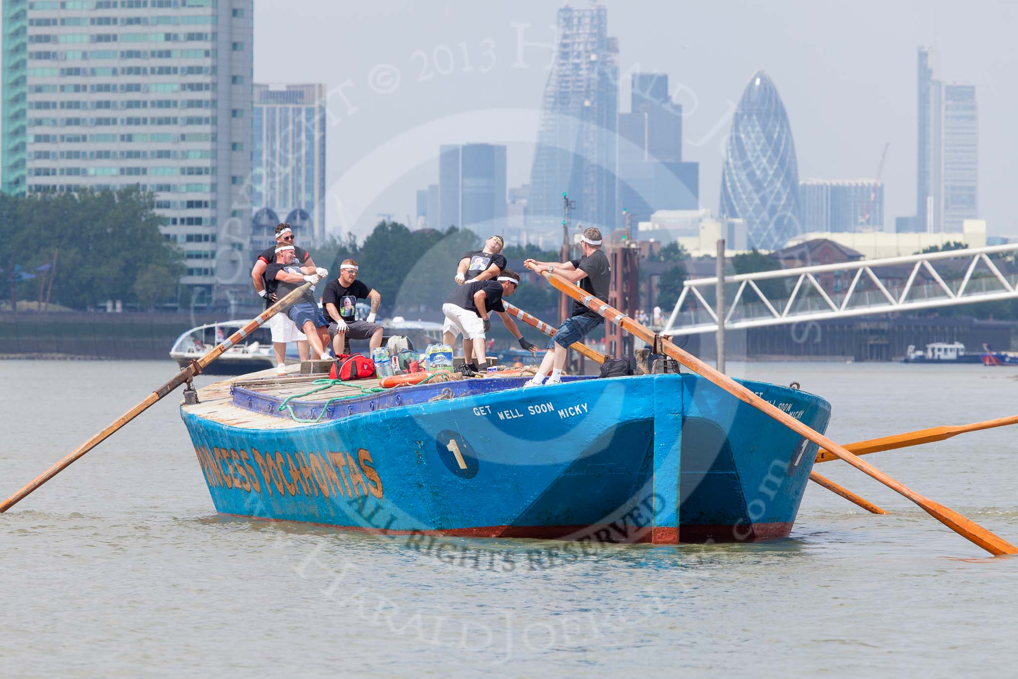 TOW River Thames Barge Driving Race 2013: Rear view of barge "Darren Lacey", by Princess Pocahontas, during the race, approaching Masthouse Terrace Pier. In the background the skyscrapers of the City of London, including the "Gherkin"..
River Thames between Greenwich and Westminster,
London,

United Kingdom,
on 13 July 2013 at 12:41, image #174