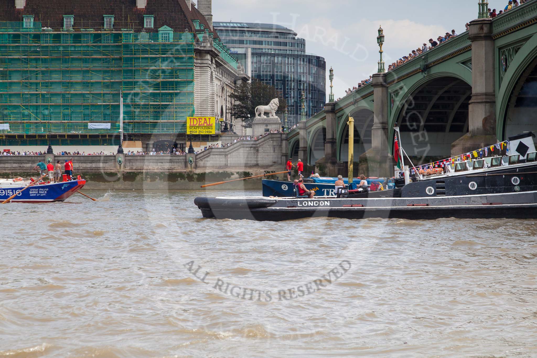 TOW River Thames Barge Driving Race 2013: Barge "Diana", by Trinity Buoy Wharf, crossing the finish of the race at Westminster Bridge, followed by barge "Steve Faldo" by Capital Pleasure Boats..
River Thames between Greenwich and Westminster,
London,

United Kingdom,
on 13 July 2013 at 14:18, image #428