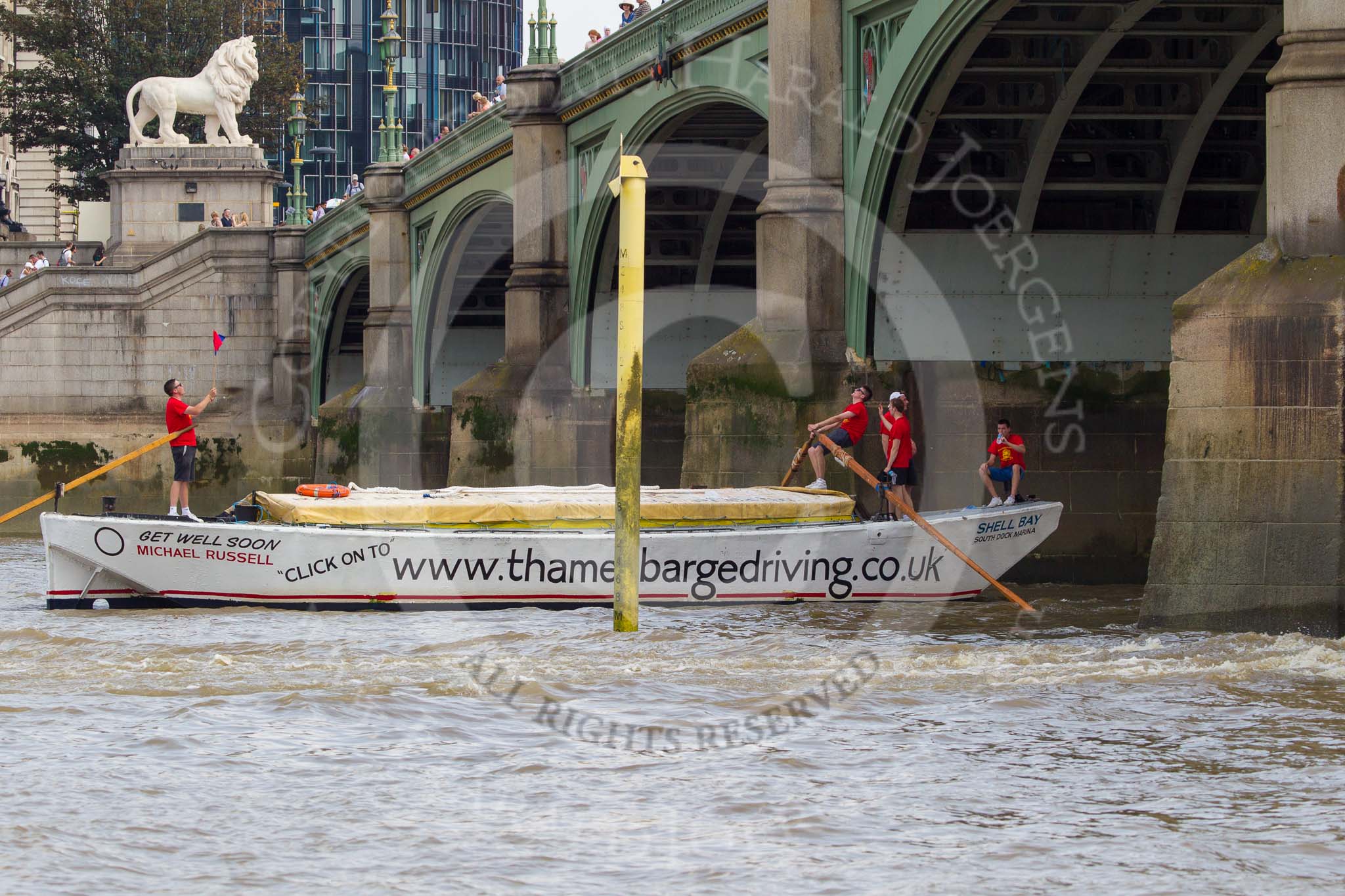 TOW River Thames Barge Driving Race 2013: Barge ""Shell Bay" by South Dock Marina,  crosses the finish of the race at Westminster Bridge..
River Thames between Greenwich and Westminster,
London,

United Kingdom,
on 13 July 2013 at 14:24, image #450