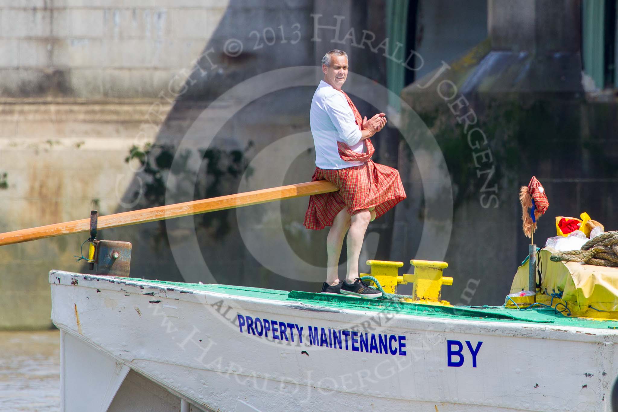 TOW River Thames Barge Driving Race 2013: The steerer, applauding, as barge "Hoppy", by GPS Fabrication, crosses the finish line of the race at Westminster Bridge..
River Thames between Greenwich and Westminster,
London,

United Kingdom,
on 13 July 2013 at 14:27, image #465