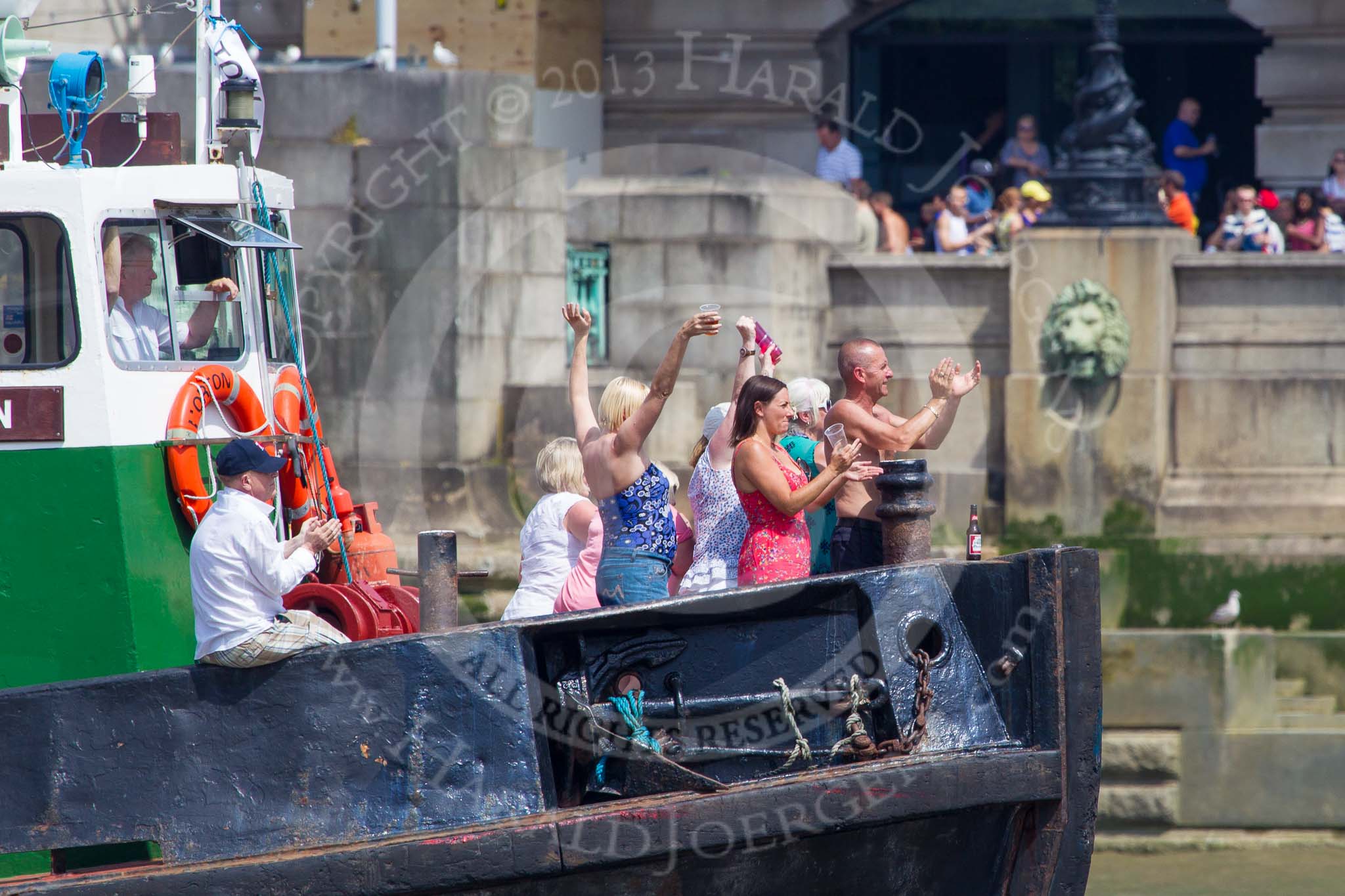 TOW River Thames Barge Driving Race 2013: Guests on board of tug "Horton" applauding "Darren Lacey" at the fnish line of the race..
River Thames between Greenwich and Westminster,
London,

United Kingdom,
on 13 July 2013 at 14:31, image #480