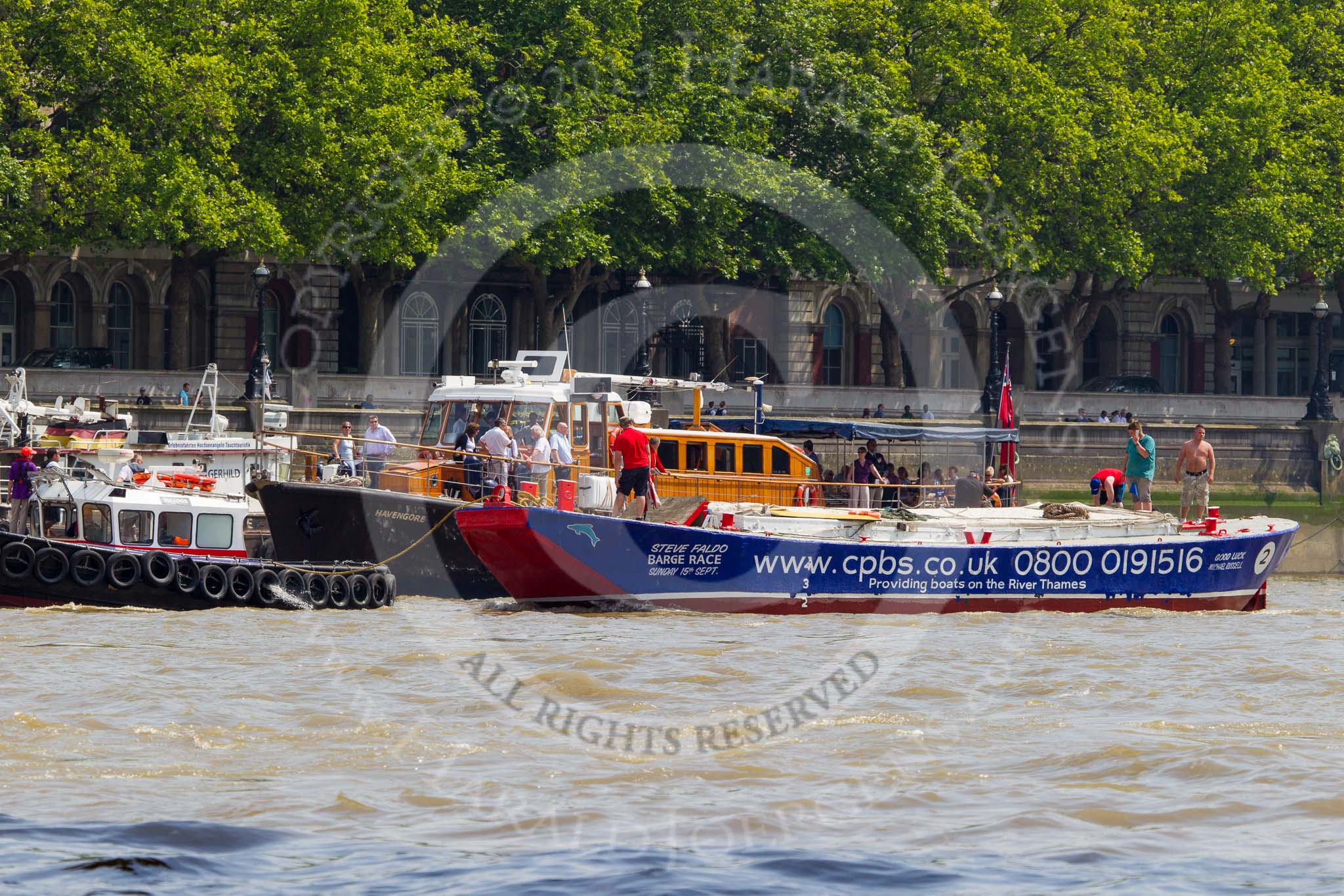 TOW River Thames Barge Driving Race 2013: Barge "Steve Faldo" by Capital Pleasure Boats, behind the finish line at Westminster Bridge, ready to be towed back to Greenwich by tug "Bulldog". Behind them is MV Havengore, hosting VIP guests..
River Thames between Greenwich and Westminster,
London,

United Kingdom,
on 13 July 2013 at 14:33, image #486