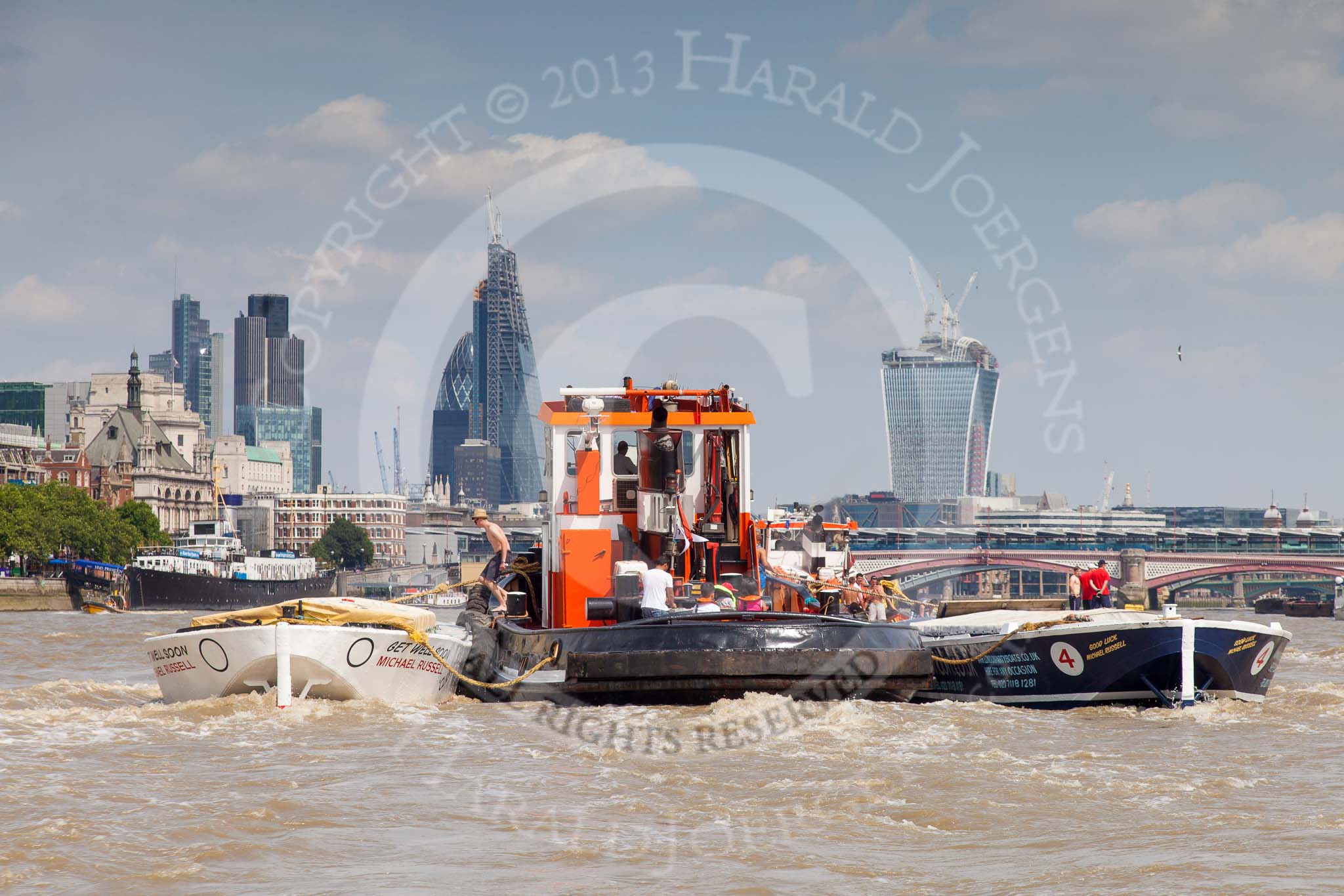 TOW River Thames Barge Driving Race 2013: GPS Marine tug "GPS India", pulling barge "Benjamin", by London Party Boats, and barge "Shell Bay" by South Dock Marina, back to Greenwich. In the background the London skyscapers, the "Gherkin", the "Cheesegrater", and the "Walkie Talkie"..
River Thames between Greenwich and Westminster,
London,

United Kingdom,
on 13 July 2013 at 14:48, image #529