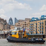 TOW River Thames Barge Driving Race 2013: The S. Walsh tug "SWS Breda"passing the Royal Navy "HMS President" andd the "Gherkin" building..
River Thames between Greenwich and Westminster,
London,

United Kingdom,
on 13 July 2013 at 13:43, image #382