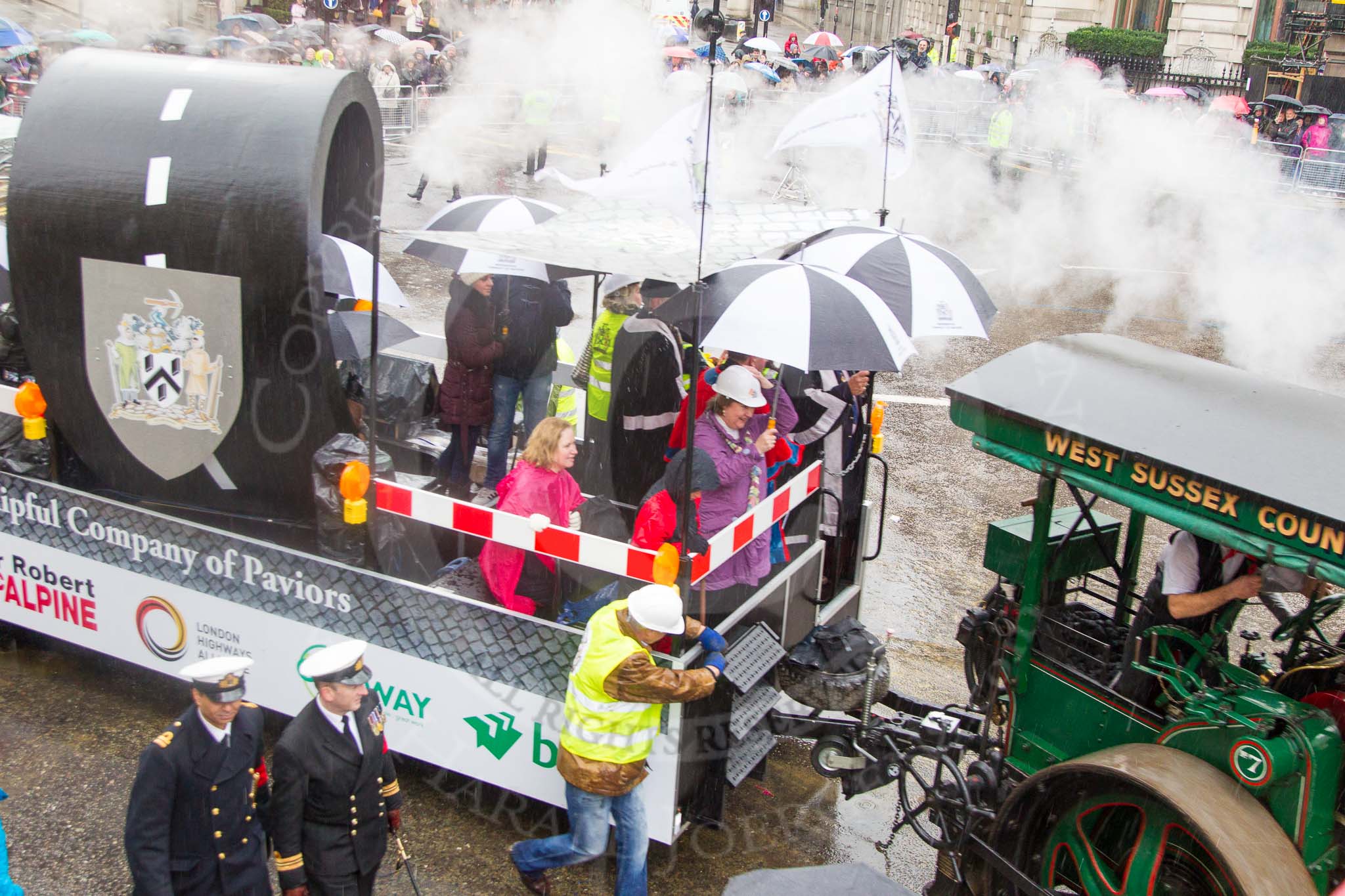 Lord Mayor's Show 2013: 70-Worshipful Company of Paviors-which brings together construction-industry professionals involved with roads and pavements.This year's float features the 'pig' that mediaeval paviors would have cleared from city streets and it towed by a steamroller from Amberley museum..
Press stand opposite Mansion House, City of London,
London,
Greater London,
United Kingdom,
on 09 November 2013 at 11:39, image #850