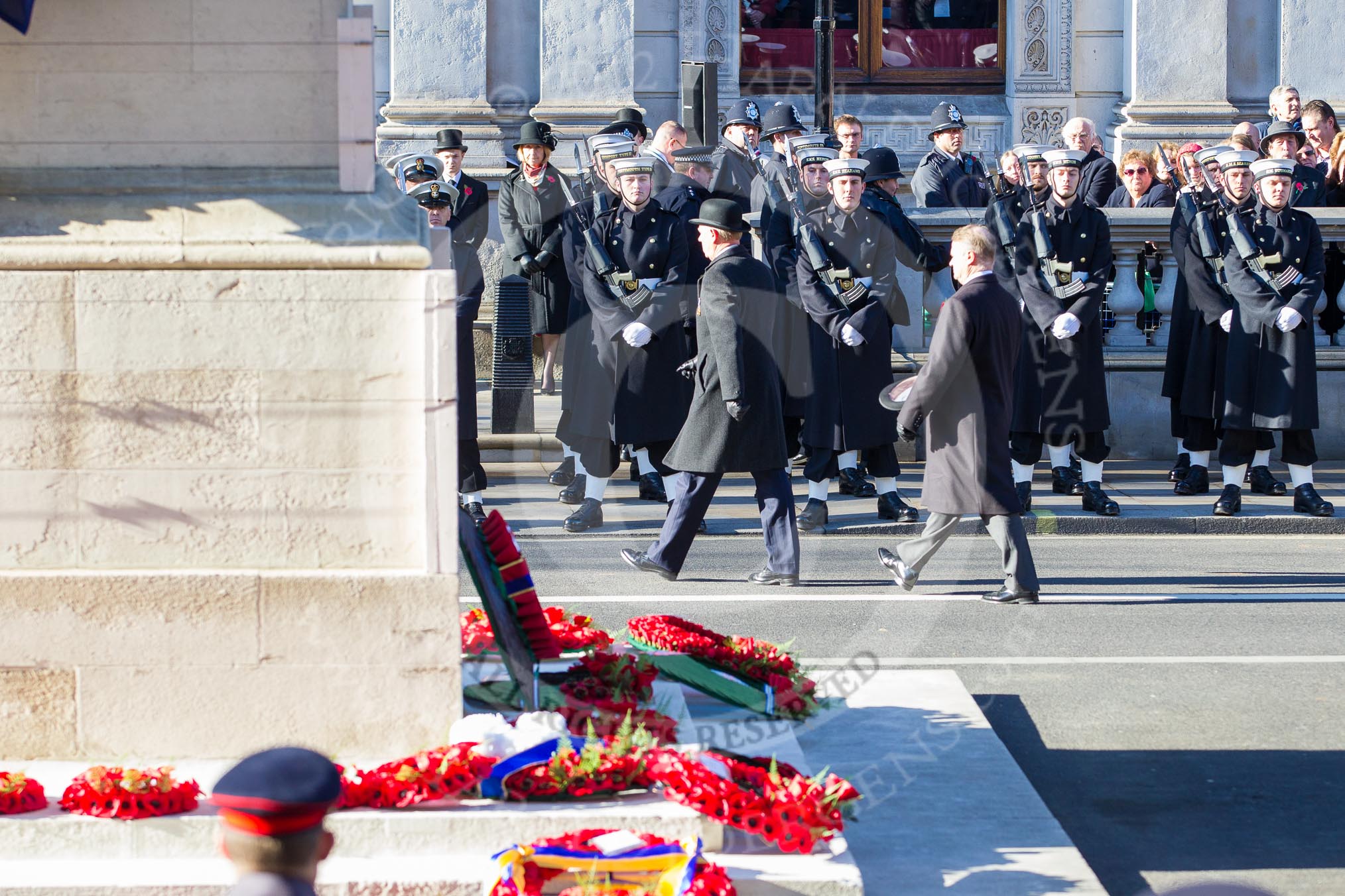 Remembrance Sunday 2012 Cenotaph March Past: Leaving Whitehall - Sir Peter Wilkinson, President of the Royal British Legion. In the foreground the Cenotaph with wreaths maade of bright red poppies..
Whitehall, Cenotaph,
London SW1,

United Kingdom,
on 11 November 2012 at 11:30, image #21