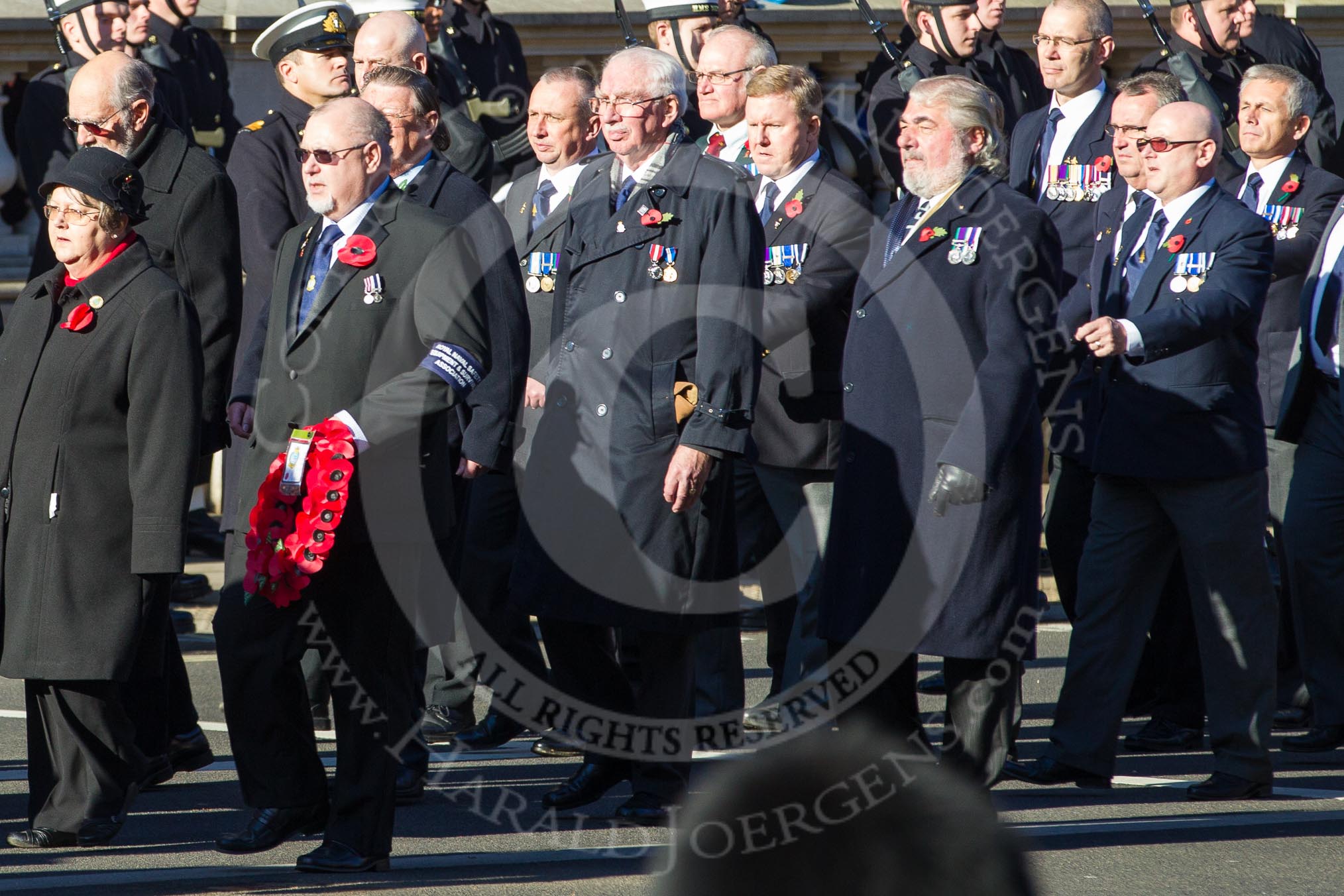 Remembrance Sunday 2012 Cenotaph March Past: Group E14 - Fleet Air Arm Safety Equipment & Survival Association, in charge of service and maintenance of aircrew emergency equipment including Life-rafts, Personal Survival Packs, Parachutes and Aircrew clothing, as well as aircraft egress and land survival training. Wreath carrier and group leader is David Philpot,  Ex Chief Petty Officer (Airman) Survival Equipment..
Whitehall, Cenotaph,
London SW1,

United Kingdom,
on 11 November 2012 at 11:40, image #114