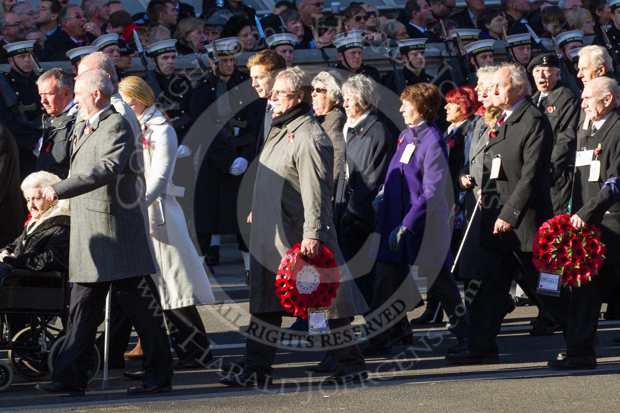 Remembrance Sunday 2012 Cenotaph March Past: Group M5  - Children of the Far East Prisoners of War and M6 - Evacuees Reunion Association..
Whitehall, Cenotaph,
London SW1,

United Kingdom,
on 11 November 2012 at 12:10, image #1468