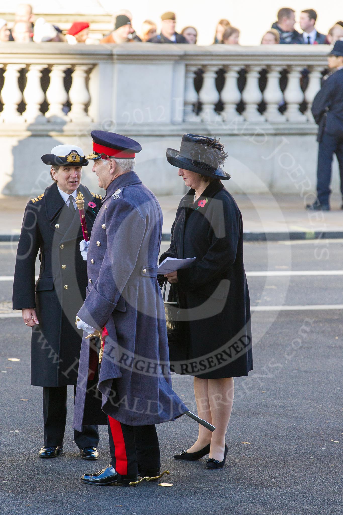 Field Marshall The Lord Guthrie of Craigiebank, who will lay a wreath later on behalf of the absent Prince of Wales, is talking to Commander Anne Sullivan, Royal Navy, Equerry to  the Princess Royal.