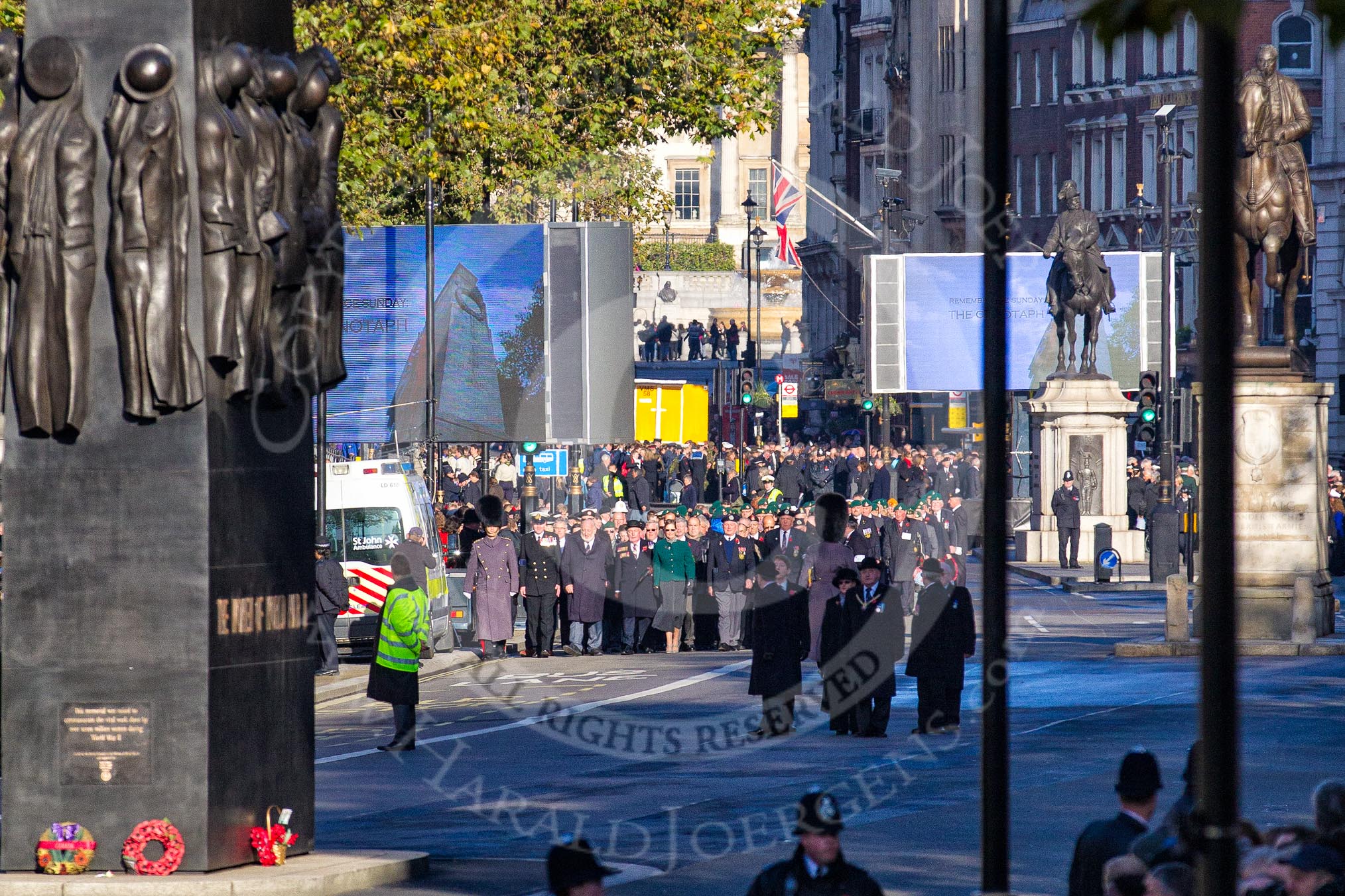 Columns of ex-Srevicemen and women, organized by the Royal British Legion, have assembled. On the left of the photo the Monument to the Women of World War II, on the right the Prince George, Duke of Cambridge  Statue, and on the very right the Statue of George, Duke of Clarence.