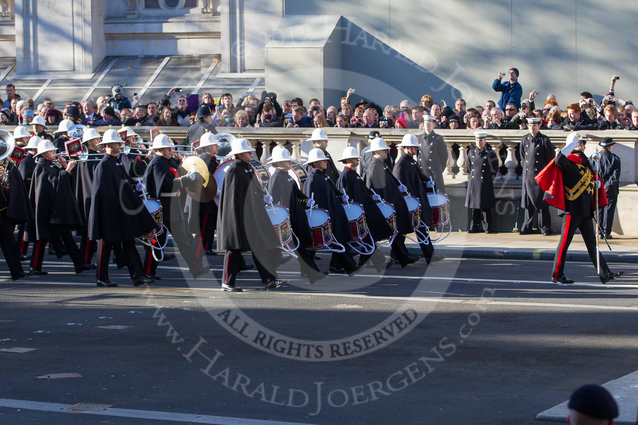 The Band of the Royal Marines arrives at the Cenotaph, the Drum Major saluting.
