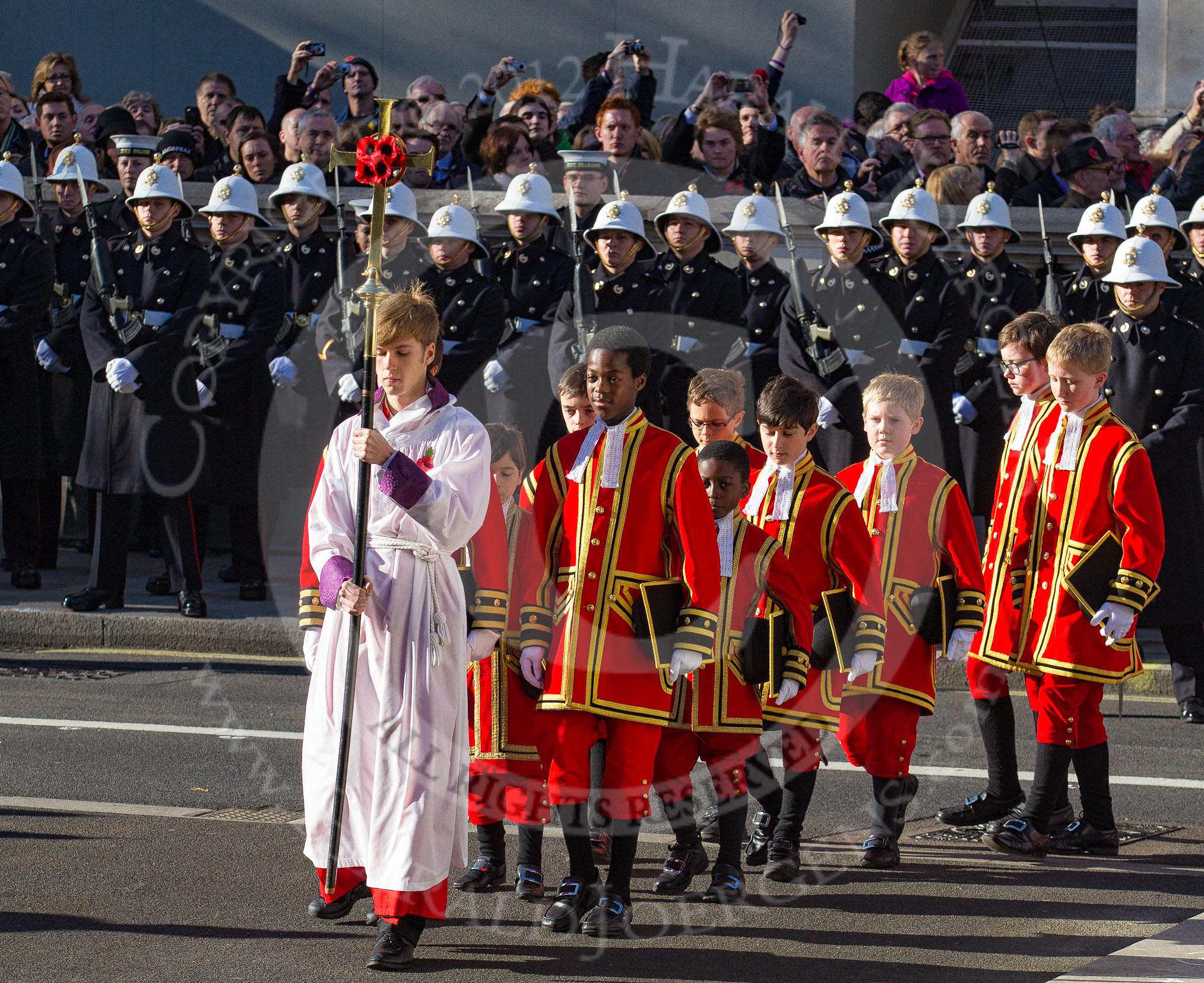 10:53am - the Choir, led by the Cross Bearer, Jack Fonseca-Burtt, followed by 10 children of the Chapel Royal, emerges from the Foreign and Commonwealth Building.