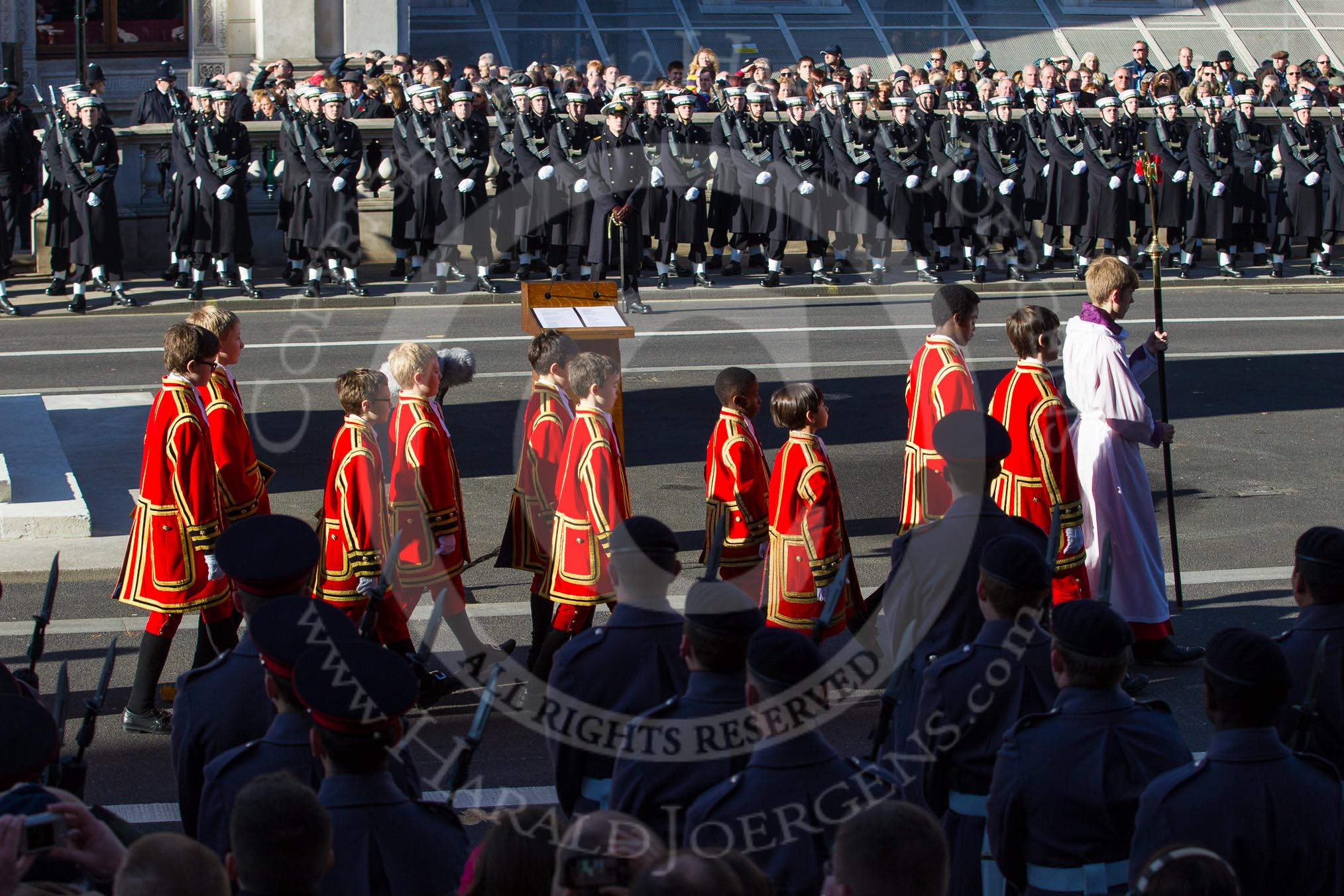 The Choir, led by the Cross Bearer, Jack Fonseca-Burtt, followed by 10 children of the Chapel Royal, getting into position on the south-eastern side of the Cenotaph.