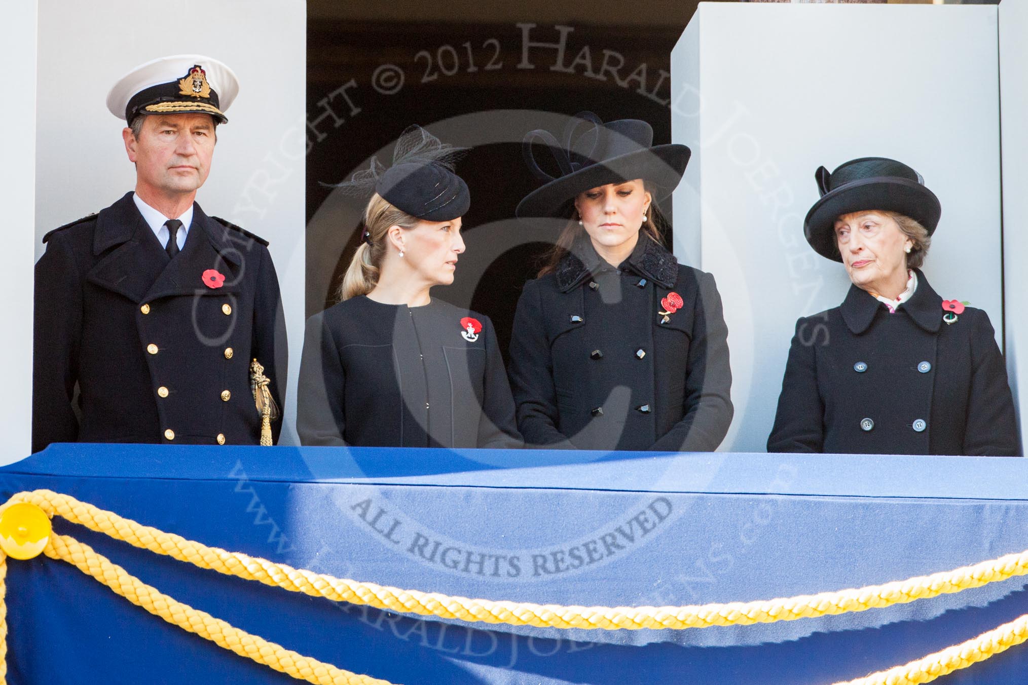 On the balcony Sir Timothy Lawrence, husband of the Princess Royal, HRH The Countess of Wessex, and HRH The Dutchess of Cambridge.