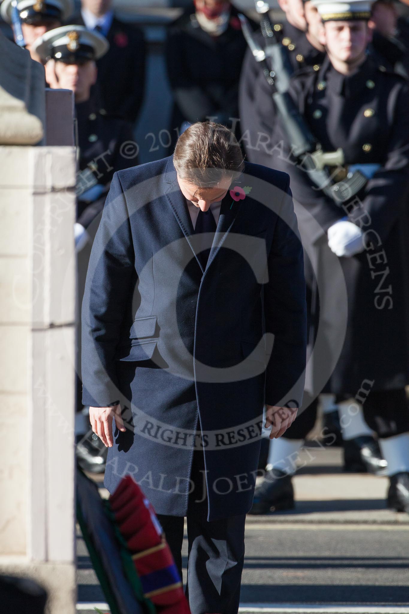The Prime Minister, David Cameron, bowing in respect after having laid a wreath at the Cenotaph.