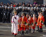 10:53am - the Choir, led by the Cross Bearer, Jack Fonseca-Burtt, followed by 10 children of the Chapel Royal, emerges from the Foreign and Commonwealth Building.