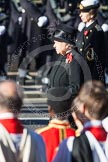 HM The Queen and, behind and out of focus, the Princess Royal, whist Beethoven's Funeral March is played.