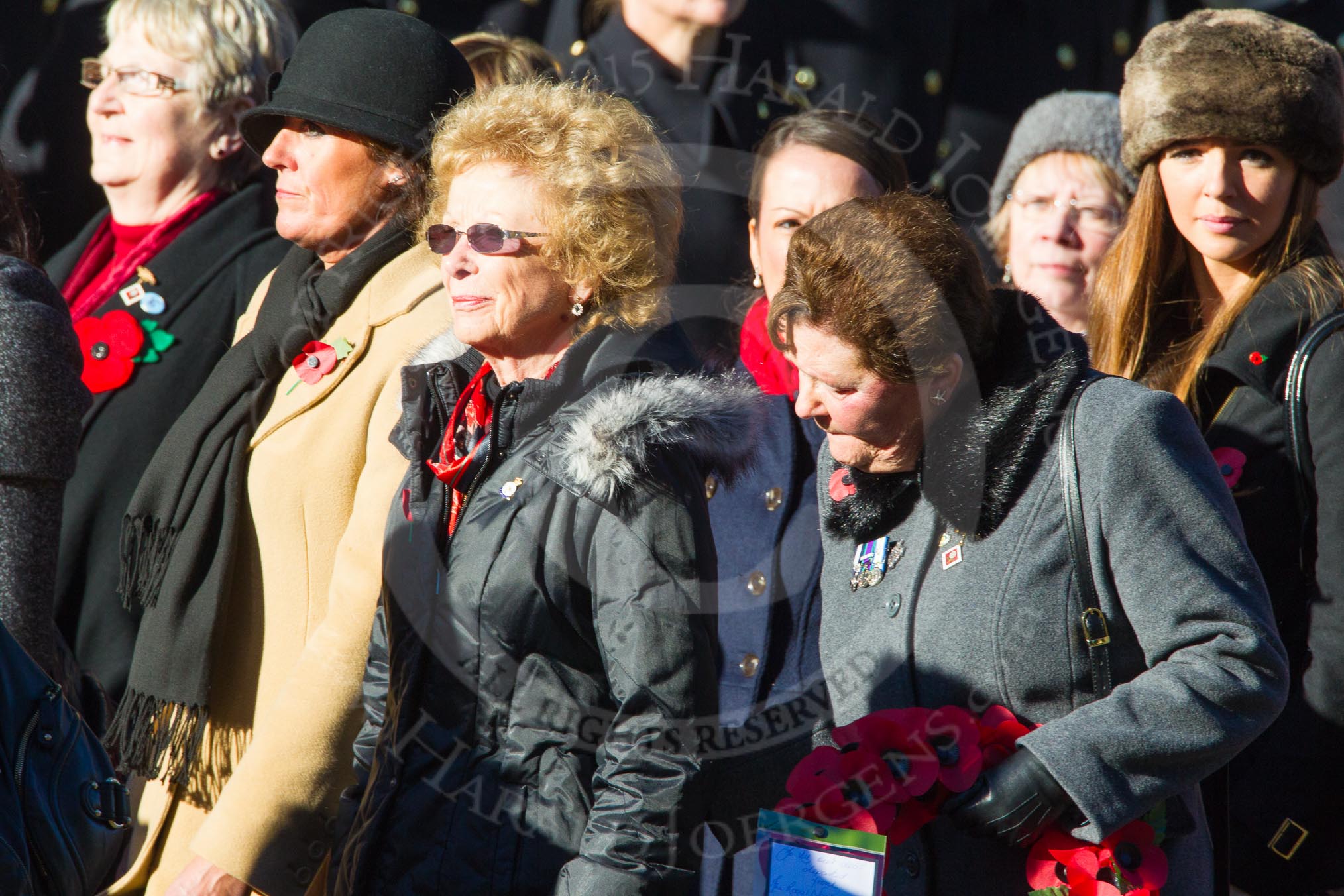 Remembrance Sunday Cenotaph March Past 2013: D1 - War Widows Association. The War Widows' Association exisits to improve the conditions of all War Widow/ers in the United Kingdom. The Association formed in 1971 following an article in a Sunday newspaper that highlighted the plight of Britain’s “forgotten women”. The Association gained charitable status in 1991 and continues to campaign against injustice..
Press stand opposite the Foreign Office building, Whitehall, London SW1,
London,
Greater London,
United Kingdom,
on 10 November 2013 at 11:38, image #28