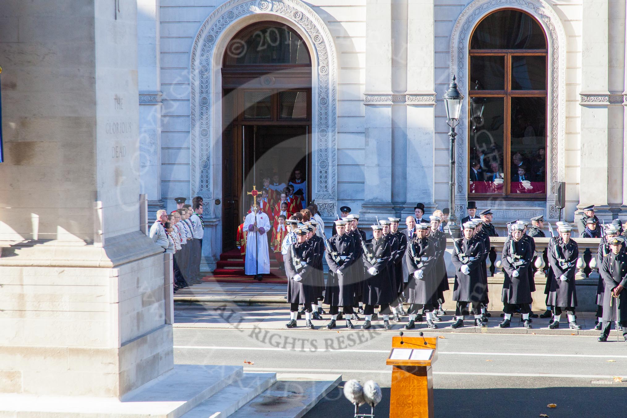 10:53am: The Choir, led by the Cross Bearer, emerges from the Foreign- and Commonwealth Building.