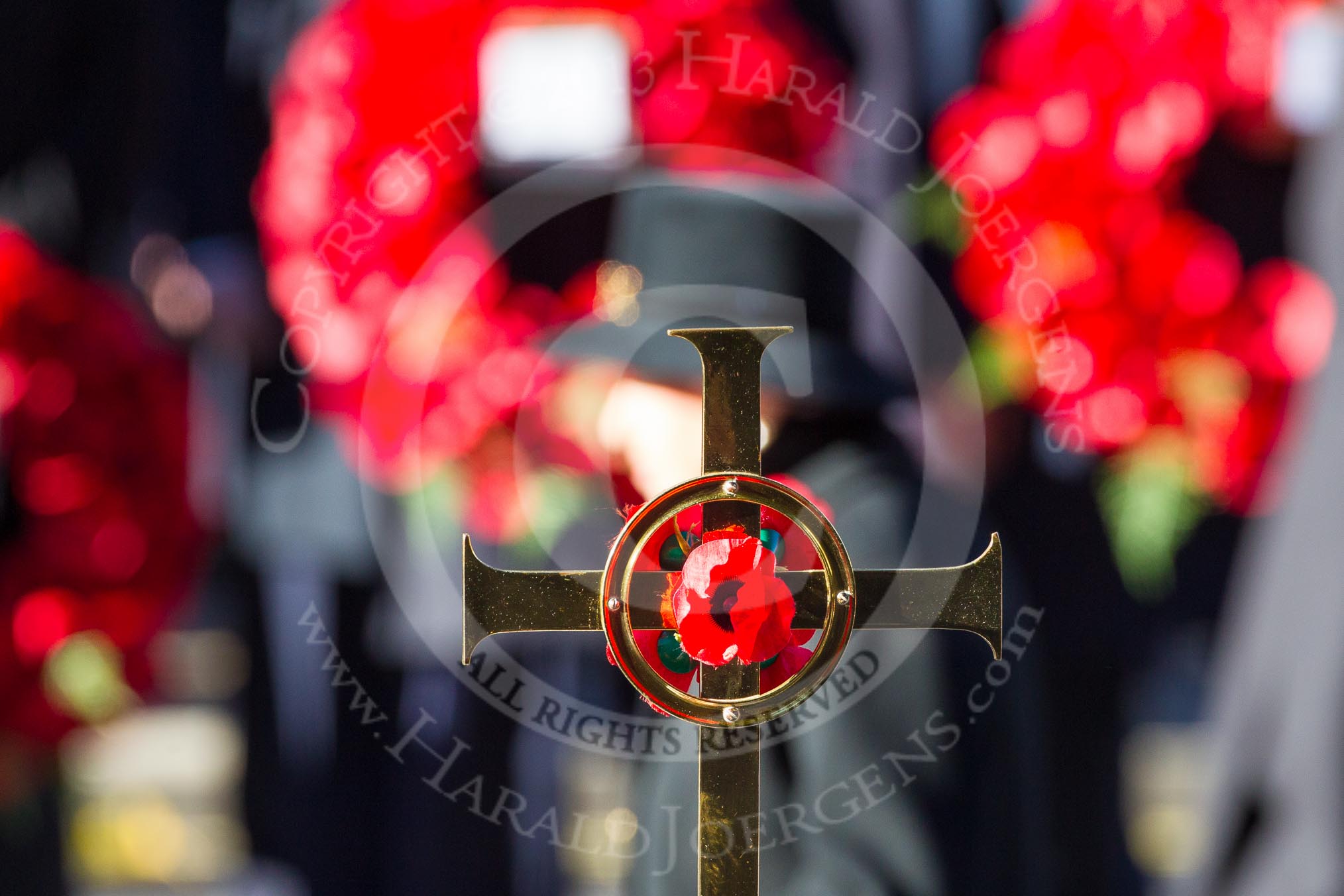 The golden cross with the poppies, held by cross bearer.