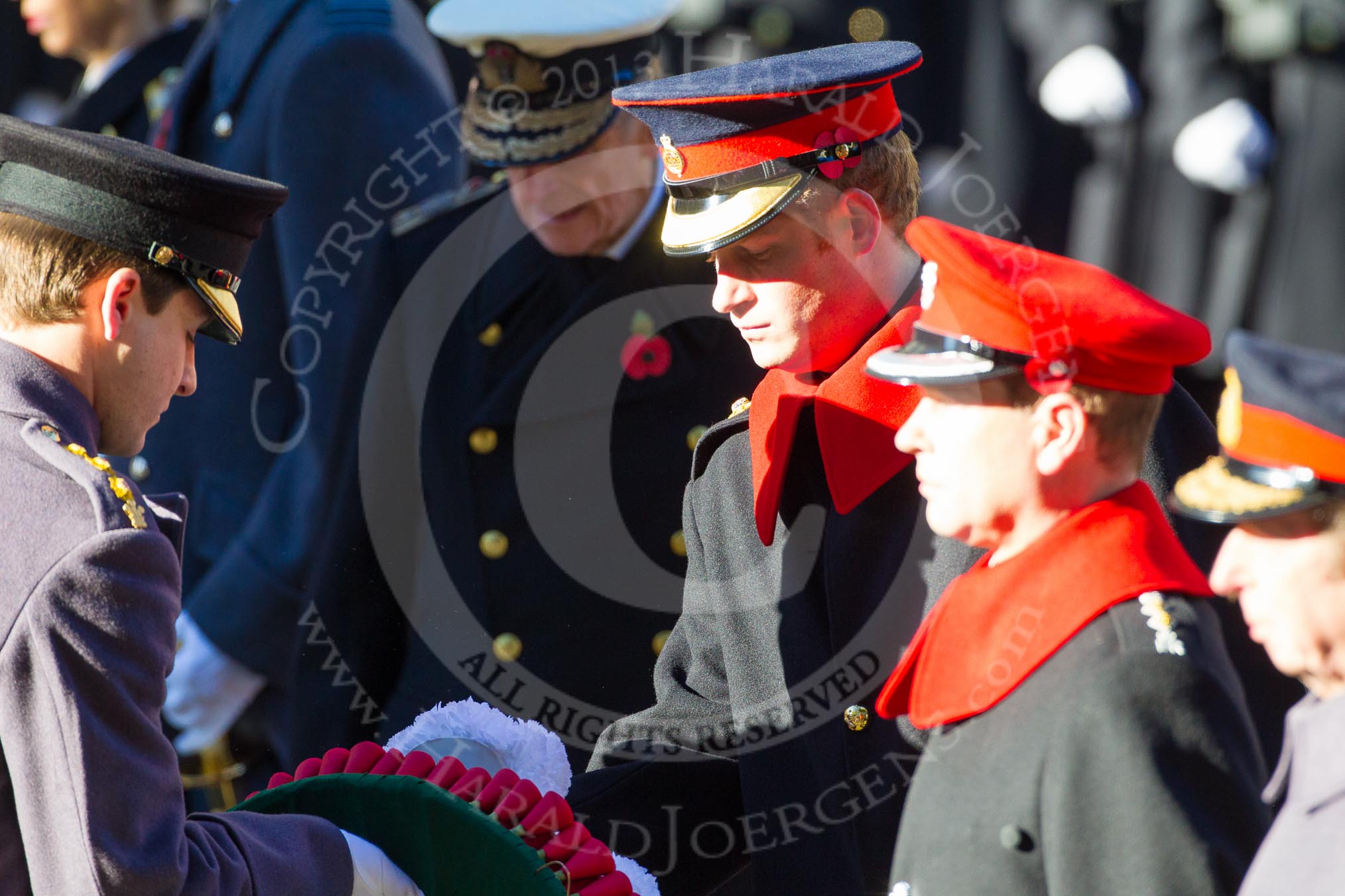HRH Prince Henry of Wales is given the wreath by Captain Charles Beare.