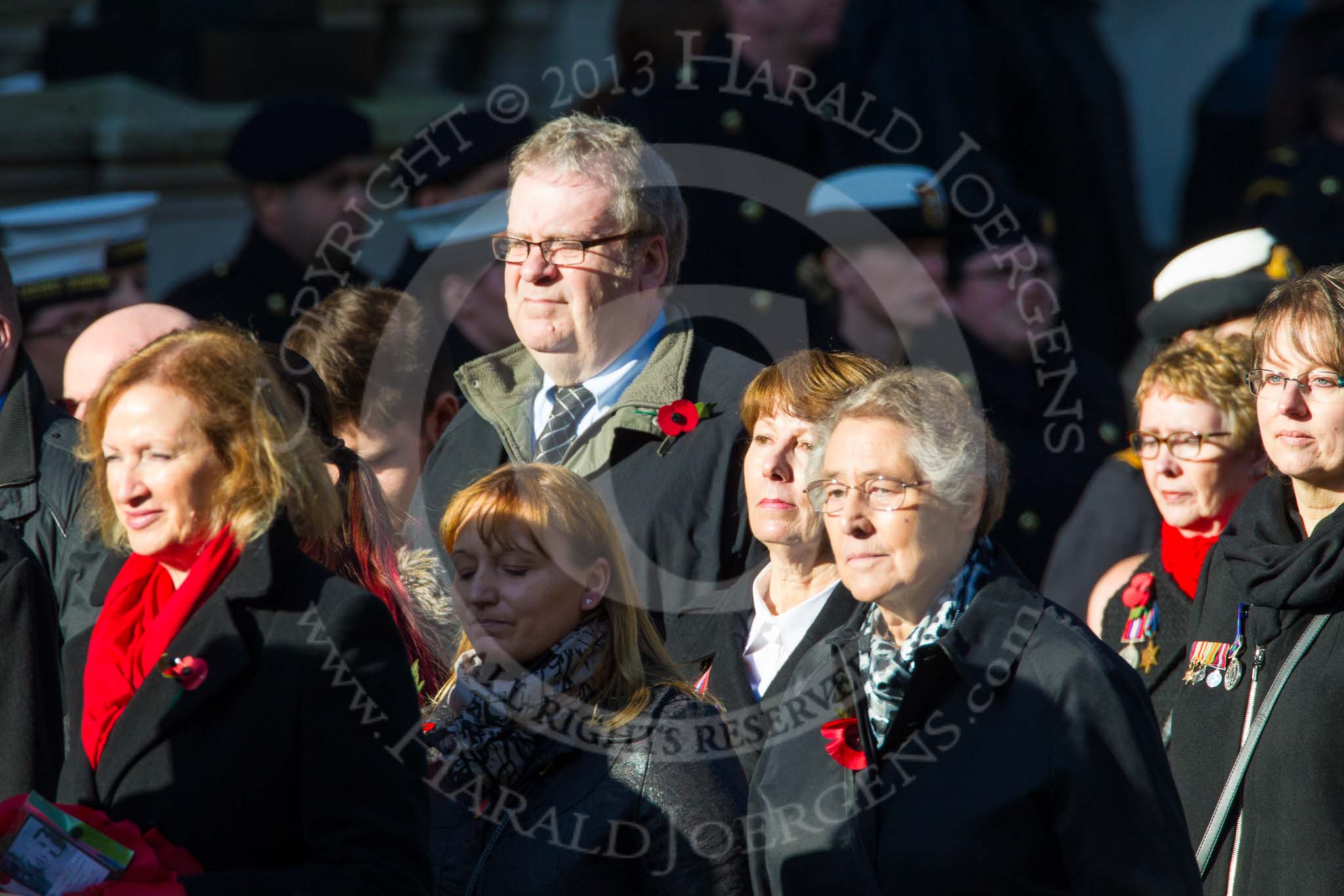 Remembrance Sunday at the Cenotaph in London 2014: Group M23 - Civilians Representing Families.
Press stand opposite the Foreign Office building, Whitehall, London SW1,
London,
Greater London,
United Kingdom,
on 09 November 2014 at 12:18, image #2160