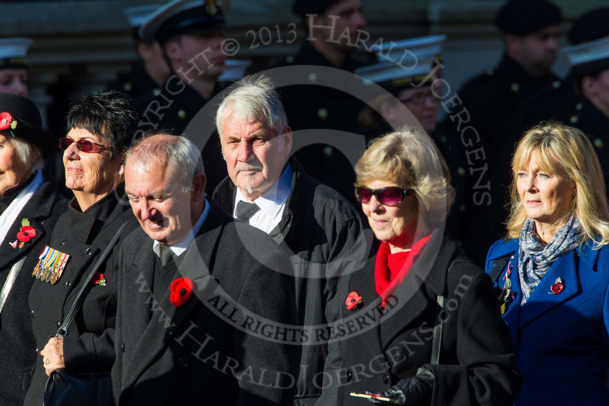 Remembrance Sunday at the Cenotaph in London 2014: Group M23 - Civilians Representing Families.
Press stand opposite the Foreign Office building, Whitehall, London SW1,
London,
Greater London,
United Kingdom,
on 09 November 2014 at 12:18, image #2170