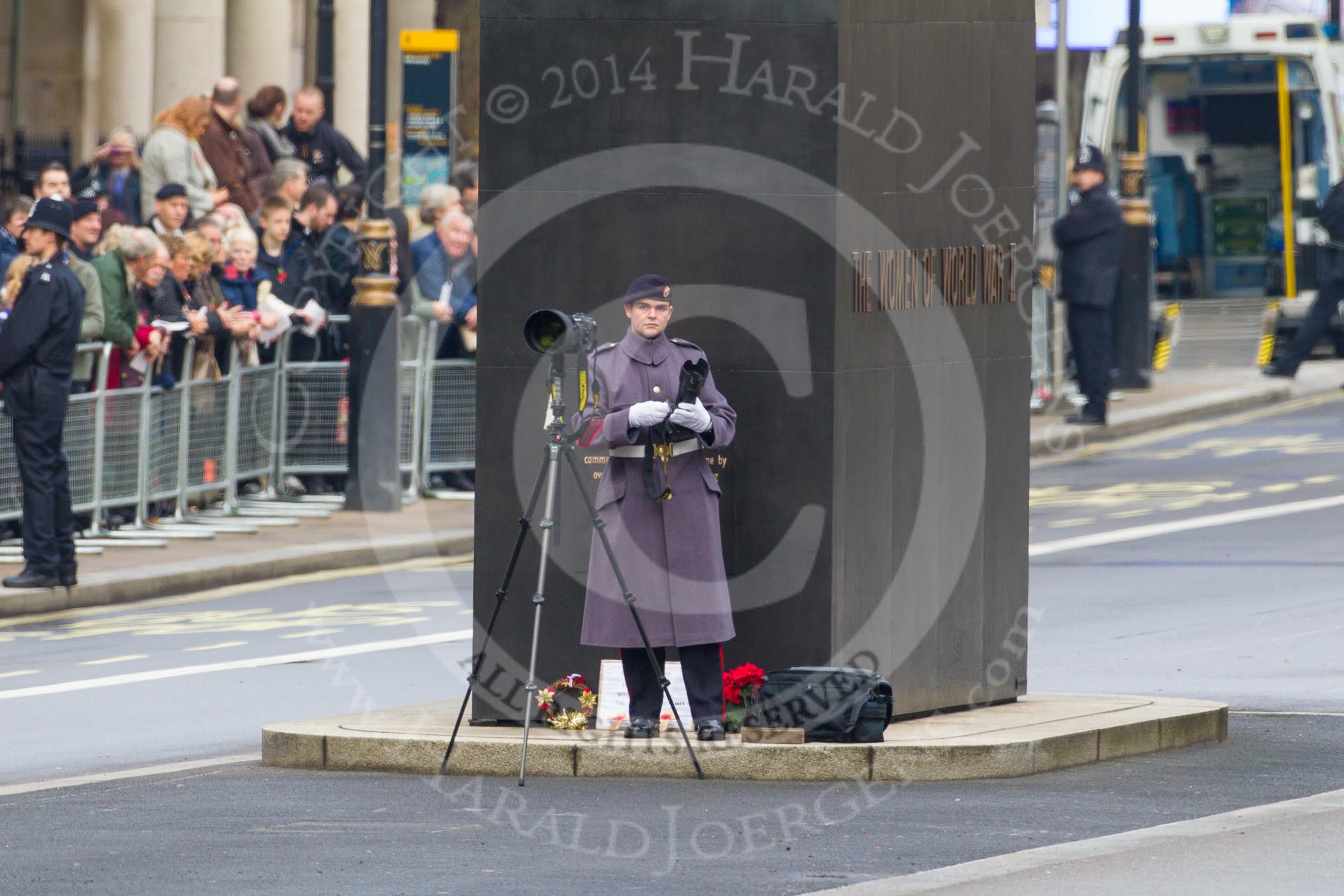 Remembrance Sunday at the Cenotaph in London 2014: An Army photographer at the Memorial for Women in World War II..
Press stand opposite the Foreign Office building, Whitehall, London SW1,
London,
Greater London,
United Kingdom,
on 09 November 2014 at 09:37, image #18
