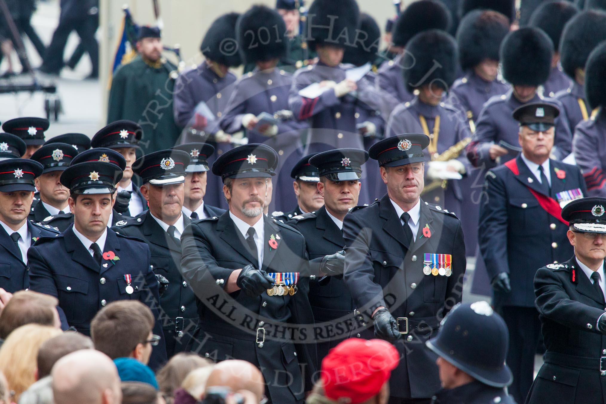 Remembrance Sunday at the Cenotaph in London 2014: A detachment of the Civil Services (Fire Brigade?) arriving at Whitehall.
Press stand opposite the Foreign Office building, Whitehall, London SW1,
London,
Greater London,
United Kingdom,
on 09 November 2014 at 10:31, image #74
