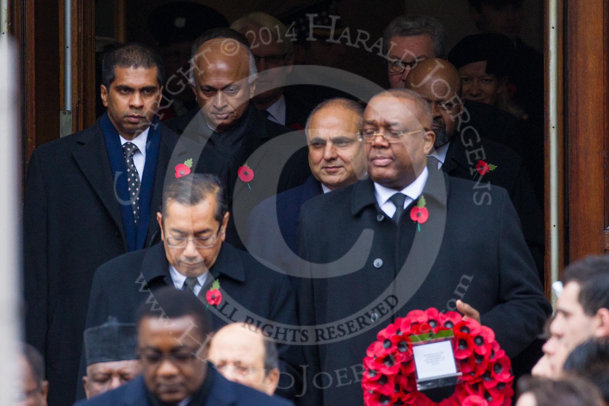 Remembrance Sunday at the Cenotaph in London 2014: The High Commissioners emerging from the door of the Foreign- and Commonwealth Office.
Press stand opposite the Foreign Office building, Whitehall, London SW1,
London,
Greater London,
United Kingdom,
on 09 November 2014 at 10:56, image #135