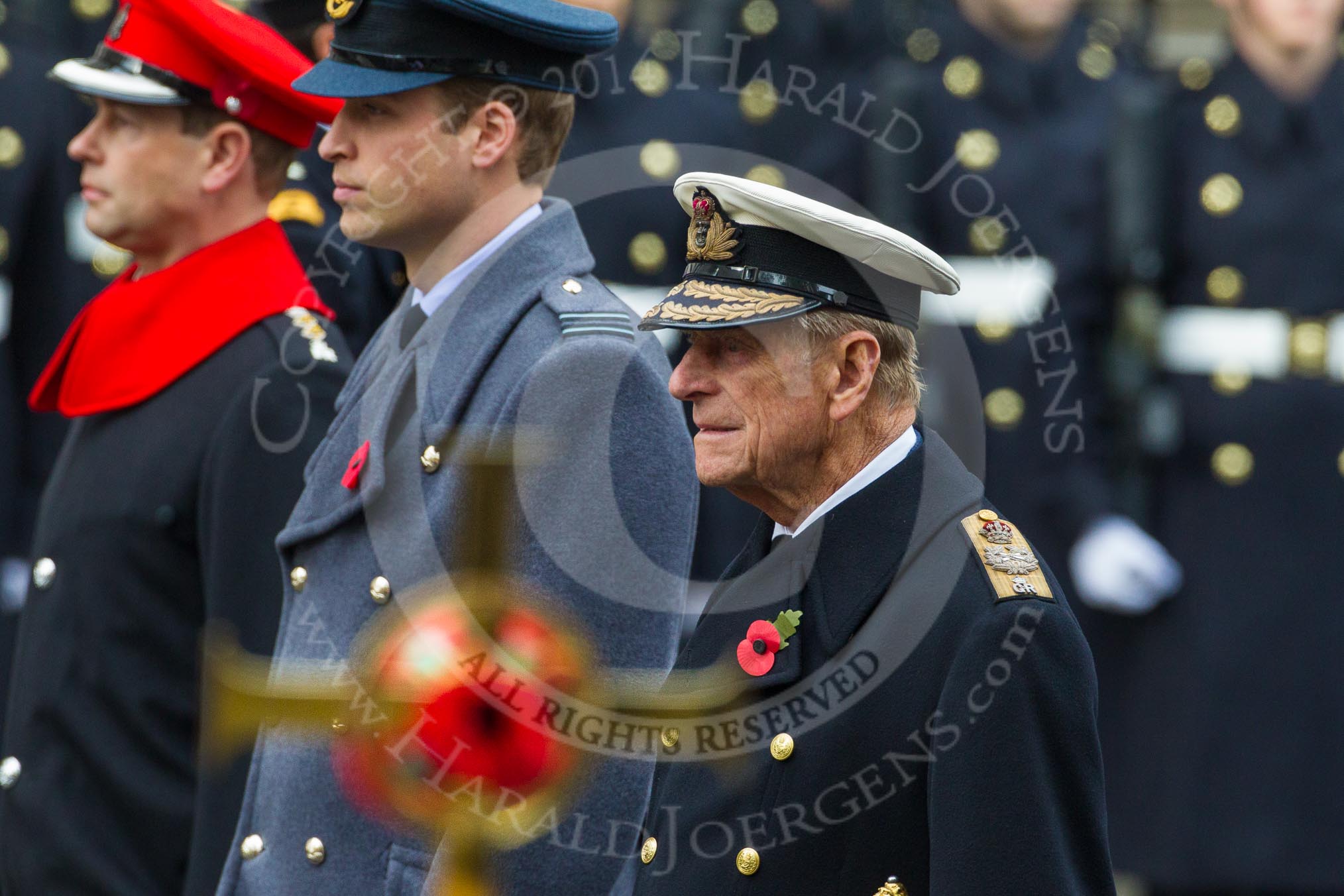 Remembrance Sunday at the Cenotaph in London 2014: HRH The Duke of Edinburgh, HRH The Duke of Cambridge, and HRH The Earl of Wessex, with the golden cross, out of focus, in front.
Press stand opposite the Foreign Office building, Whitehall, London SW1,
London,
Greater London,
United Kingdom,
on 09 November 2014 at 10:59, image #149
