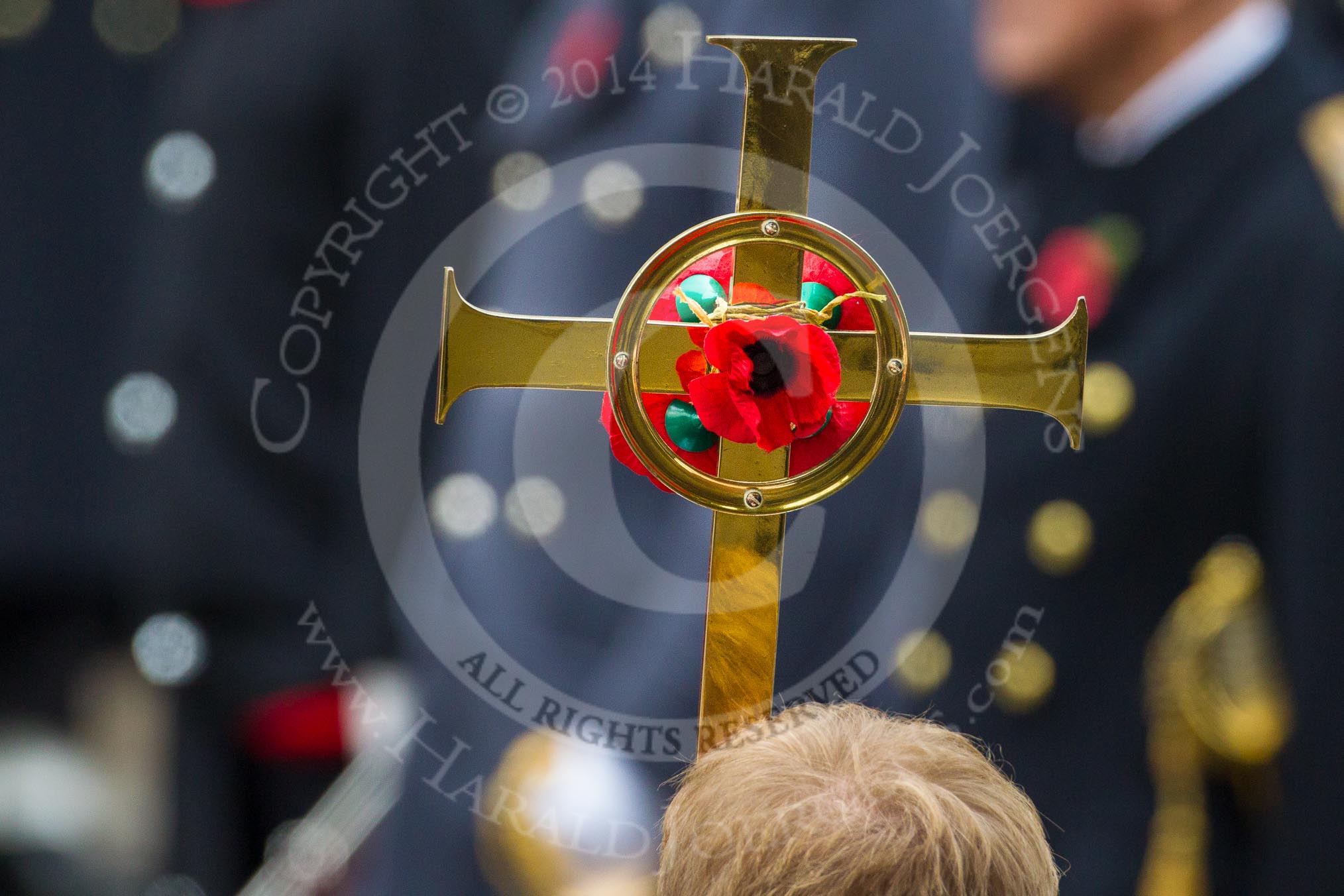 Remembrance Sunday at the Cenotaph in London 2014: The golden cross with the red poppies in front of members of the Royal Family.
Press stand opposite the Foreign Office building, Whitehall, London SW1,
London,
Greater London,
United Kingdom,
on 09 November 2014 at 11:00, image #158