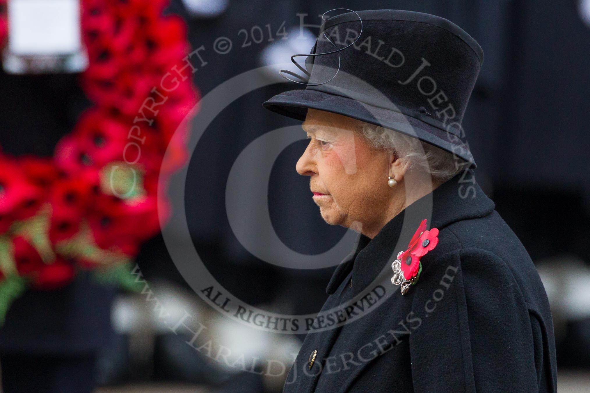 Remembrance Sunday at the Cenotaph in London 2014: HM The Queem standing in front of the Cenotaph, with a wreath by one of the politicians behind.
Press stand opposite the Foreign Office building, Whitehall, London SW1,
London,
Greater London,
United Kingdom,
on 09 November 2014 at 11:02, image #169