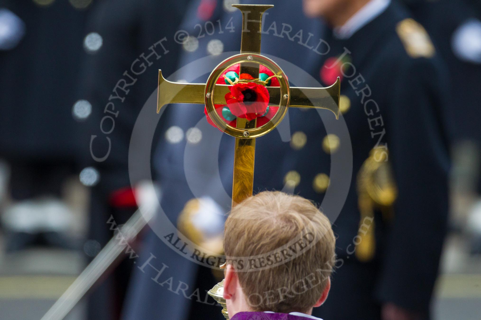 Remembrance Sunday at the Cenotaph in London 2014: The golden cross with the red poppies, carried by the Cross Bearer, in fron of members of the Royal Family.
Press stand opposite the Foreign Office building, Whitehall, London SW1,
London,
Greater London,
United Kingdom,
on 09 November 2014 at 11:03, image #183