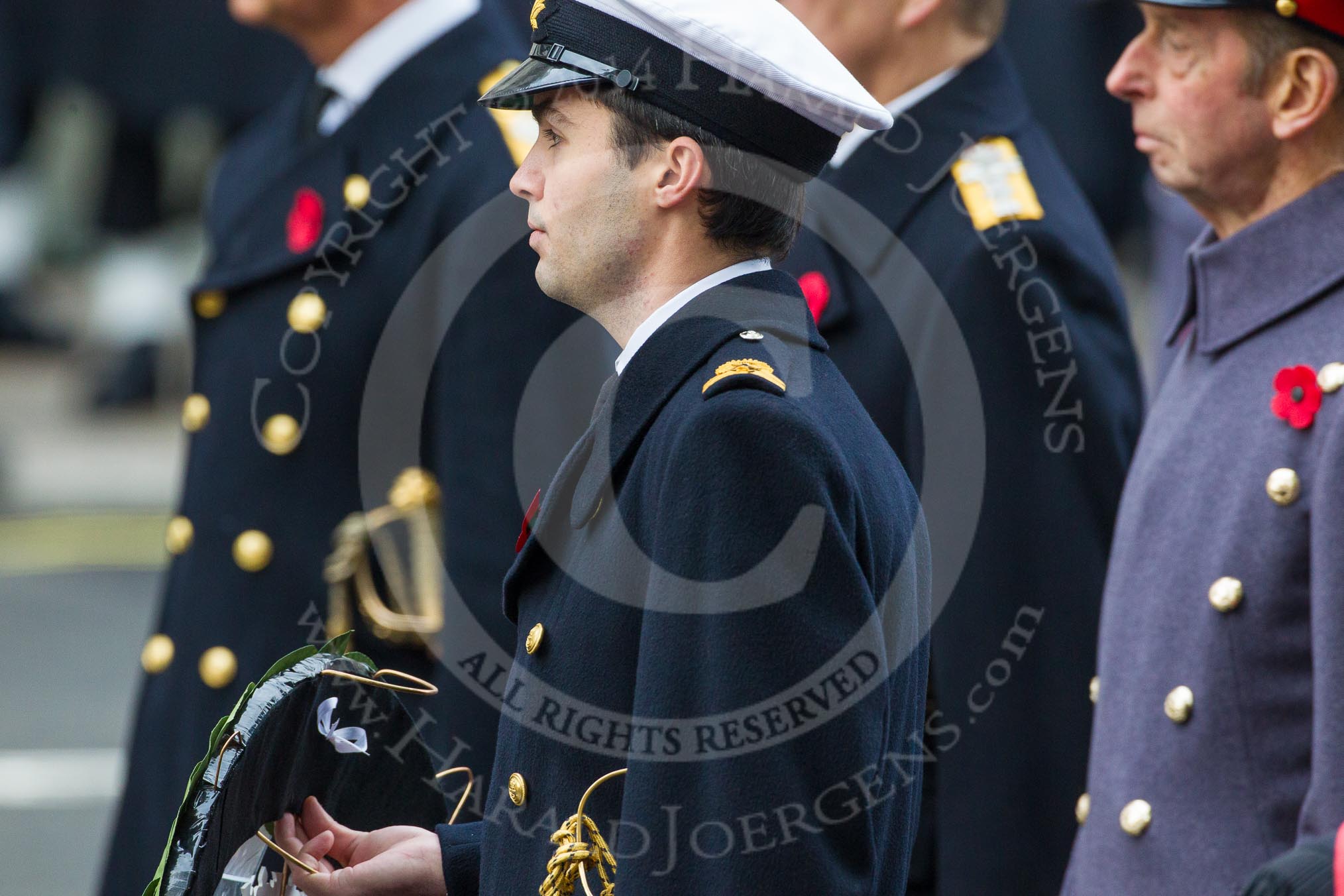 Remembrance Sunday at the Cenotaph in London 2014: Lieutenant Jack Cooper, Royal Navy, equerry to HRH The Duke of York, about to hand over the wreath.
Press stand opposite the Foreign Office building, Whitehall, London SW1,
London,
Greater London,
United Kingdom,
on 09 November 2014 at 11:05, image #206