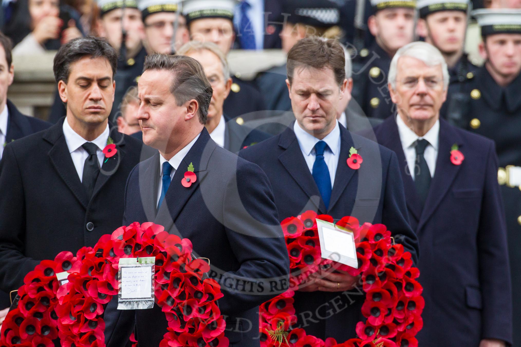 Remembrance Sunday at the Cenotaph in London 2014: Prime Minister David Cameron walking towards the Cenotaph with his wreath. Behind him Ed Milliband and Nick Clegg,.
Press stand opposite the Foreign Office building, Whitehall, London SW1,
London,
Greater London,
United Kingdom,
on 09 November 2014 at 11:06, image #216