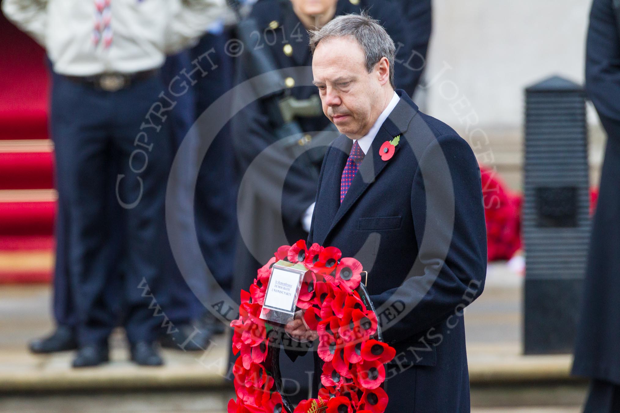 Remembrance Sunday at the Cenotaph in London 2014: The leader of the Democratic Unionist Party, Nigel Dodds, walking towards the Cenotaph with his wreath.
Press stand opposite the Foreign Office building, Whitehall, London SW1,
London,
Greater London,
United Kingdom,
on 09 November 2014 at 11:08, image #230